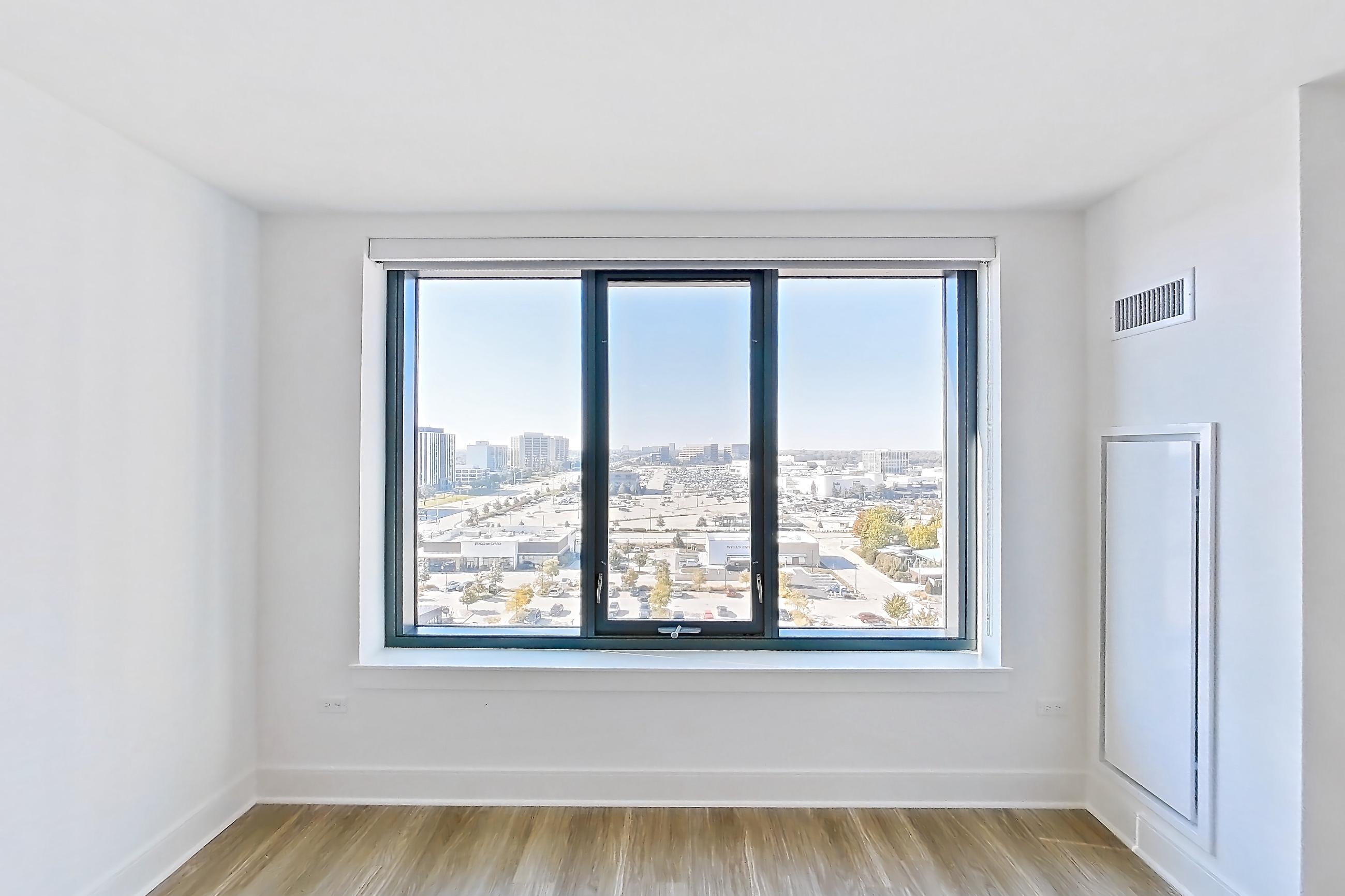 Living room with light wood-finish flooring, Apartment 1102 at One Oak Brook Commons