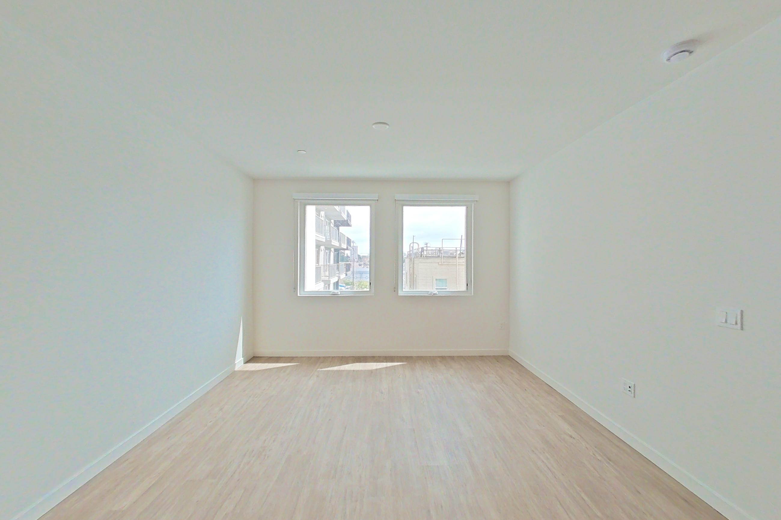 Living room with light wood-finish flooring, Apartment 419 at Denizen