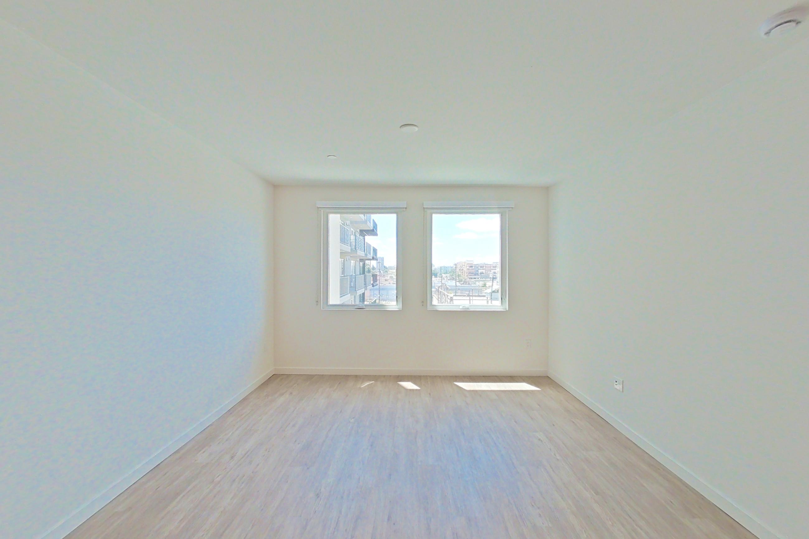 Living room with light wood-finish flooring, Apartment 519 at Denizen
