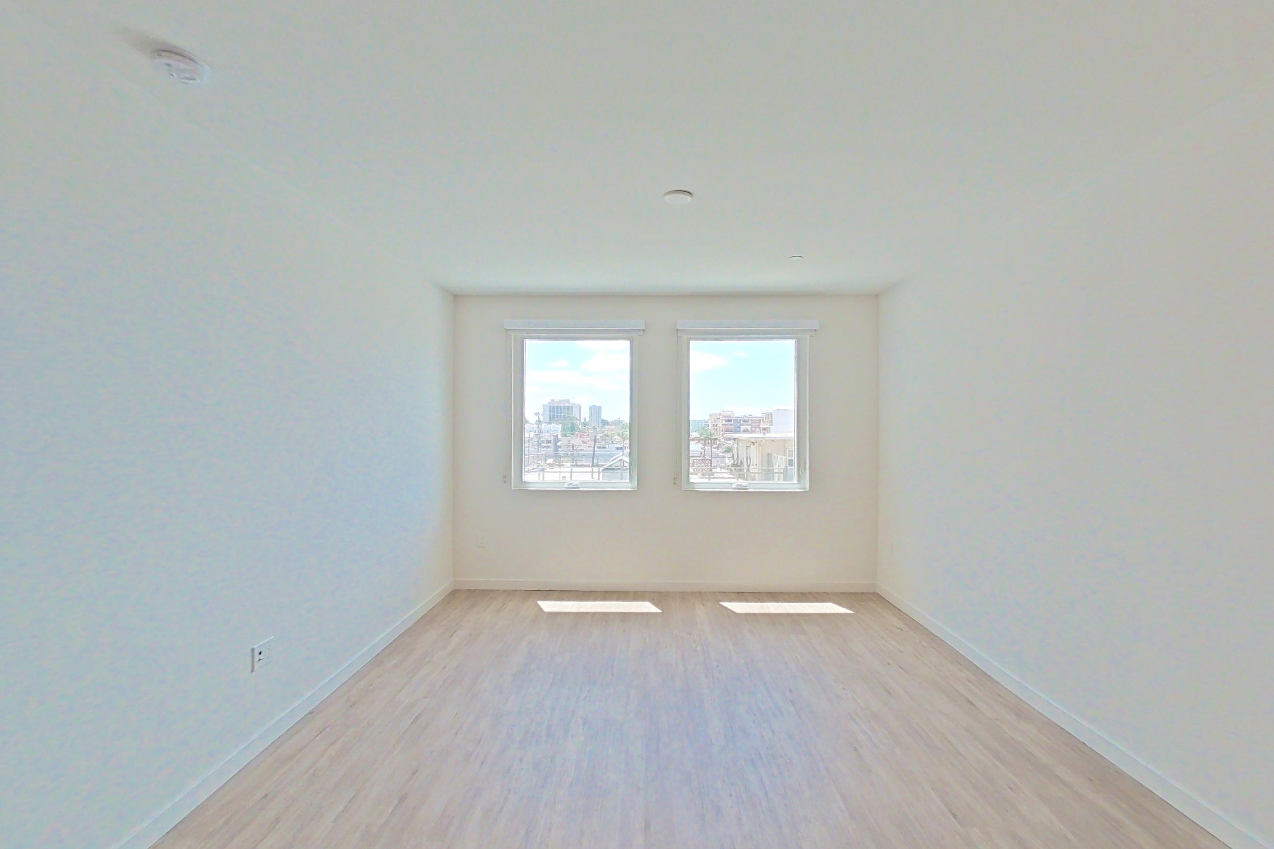 Living room with light wood-finish flooring, Apartment 520 at Denizen