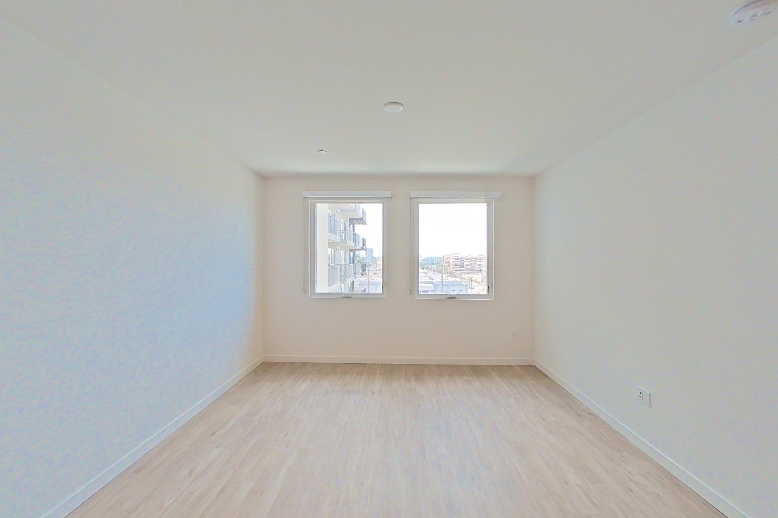 Living room with light wood-finish flooring, Apartment 619 at Denizen