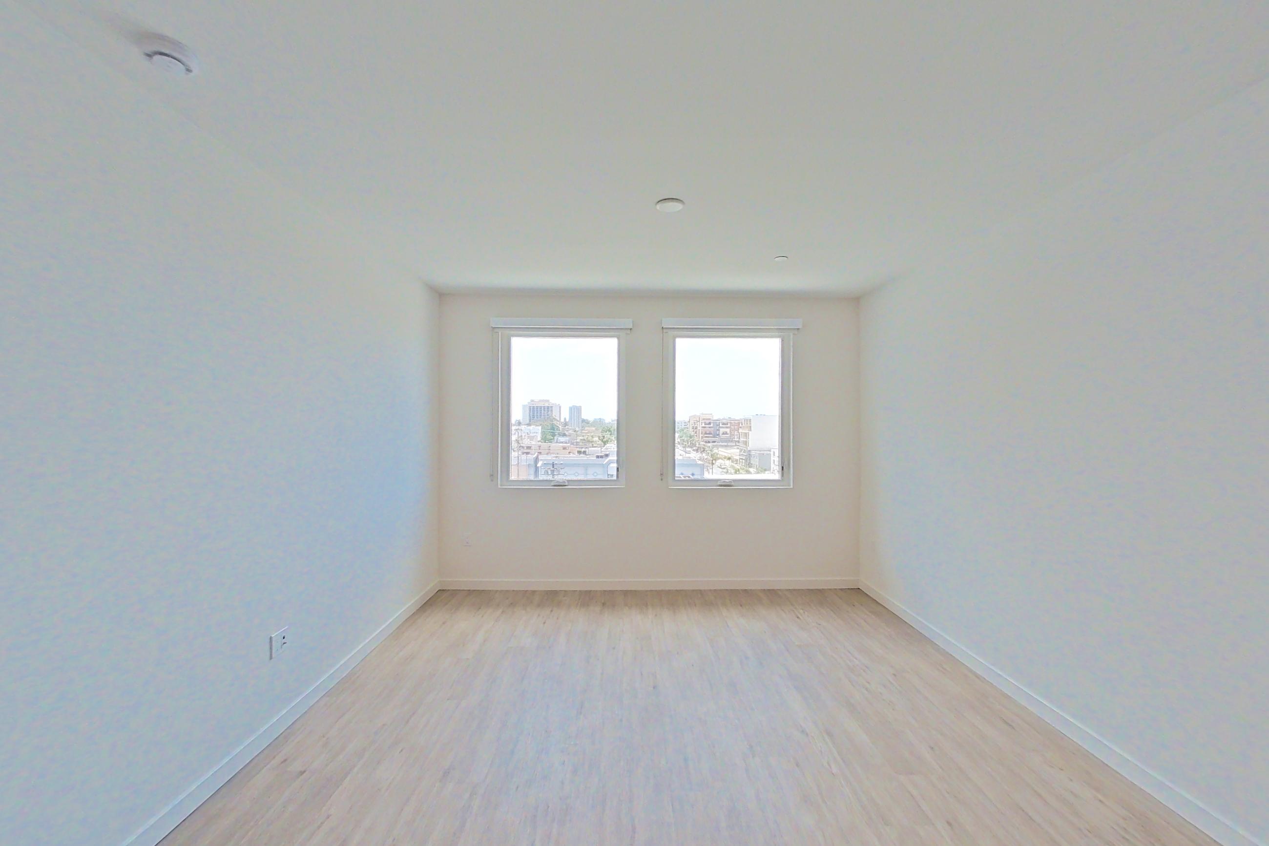 Living room with light wood-finish flooring, Apartment 620 at Denizen