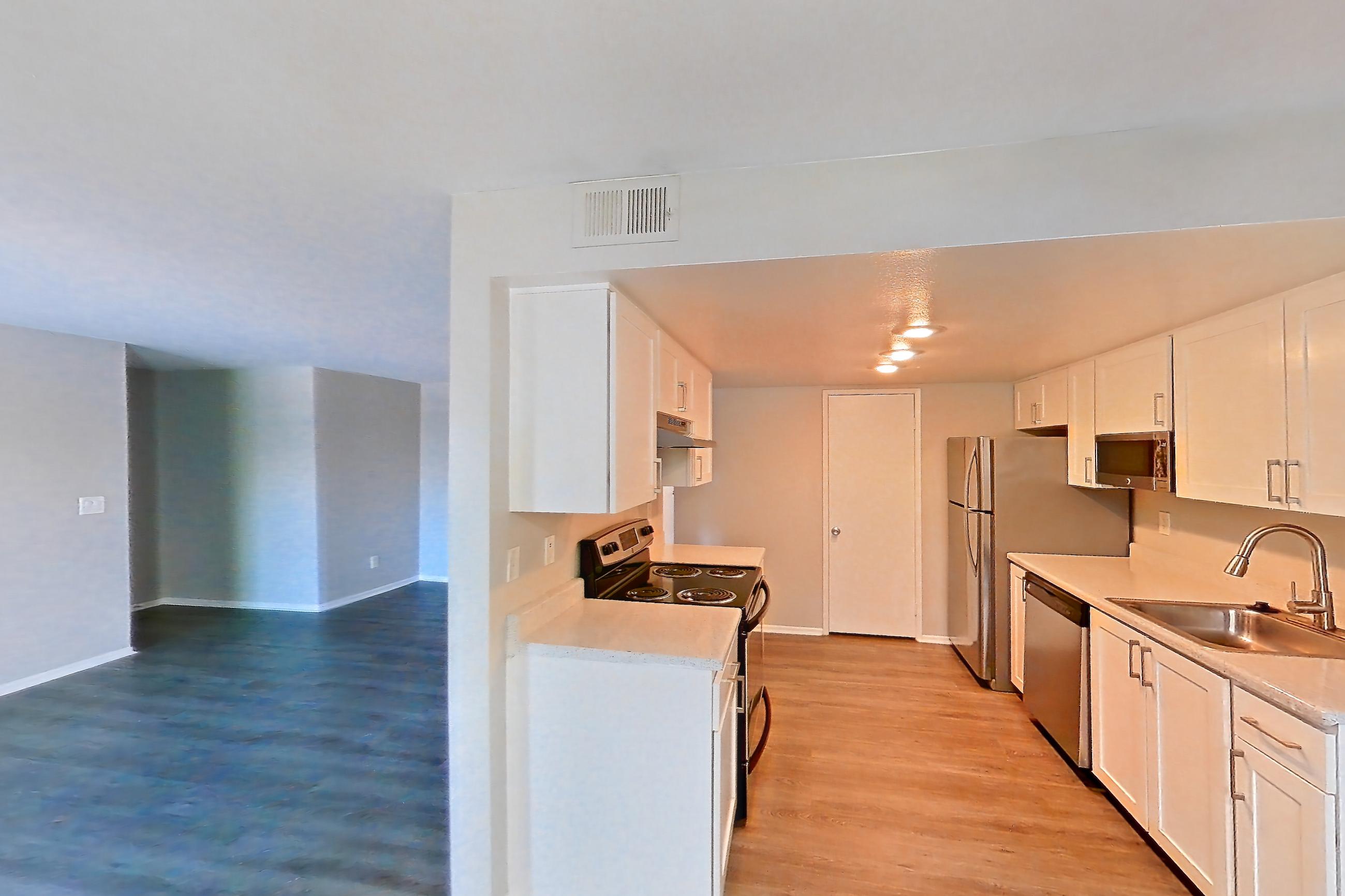Dining room with electric range, light countertops, light wood-finish flooring, oven/range, and stainless steel appliances, Apartment 03 at Avana Rancho Cucamonga