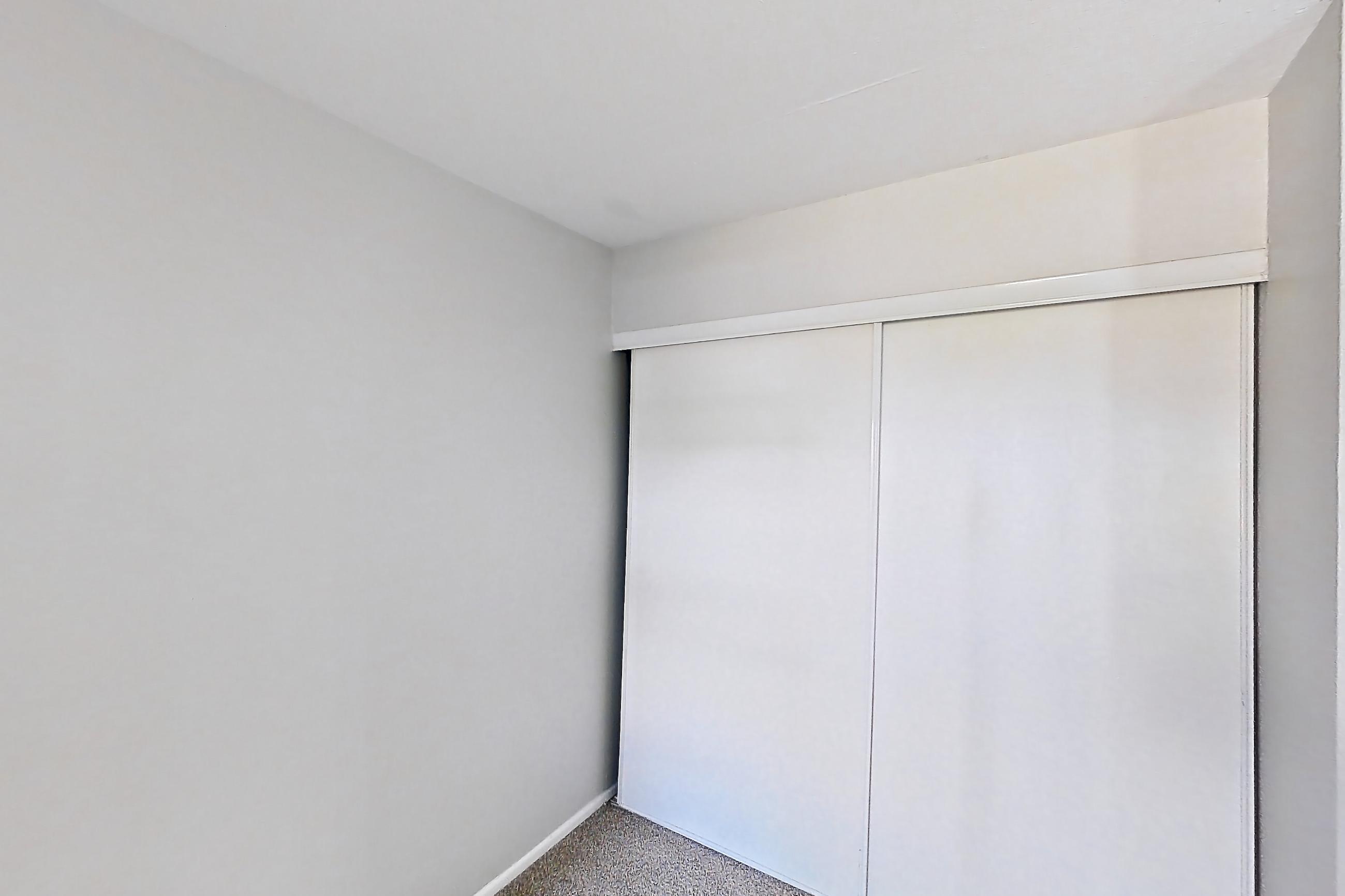 Living space with light carpet, refrigerator, and white appliances, Apartment 10 at Avana Rancho Cucamonga