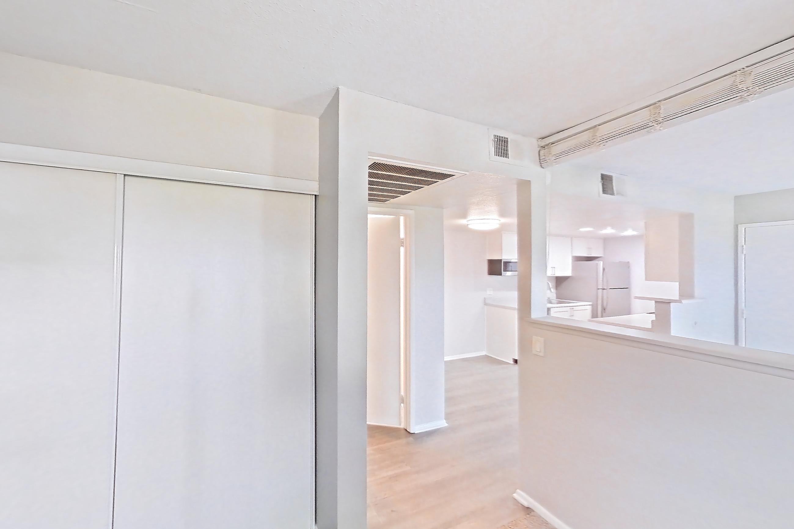 Living space with light carpet, refrigerator, and white appliances, Apartment 10 at Avana Rancho Cucamonga