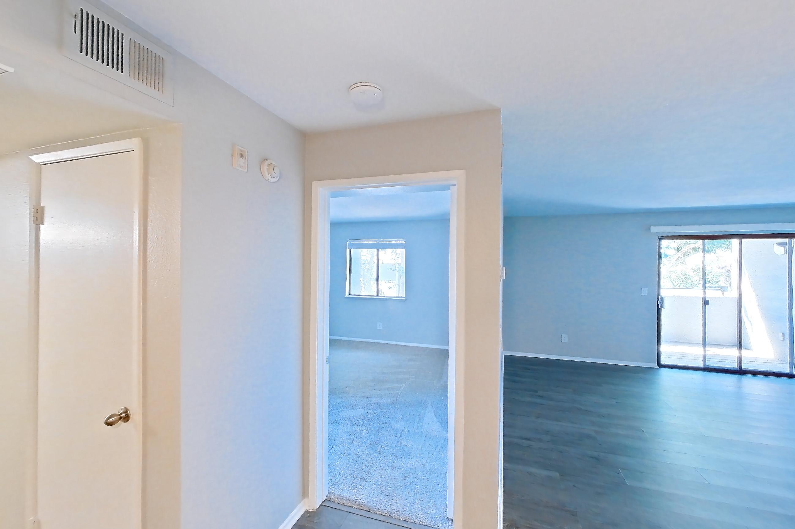 Dining room with electric range, light countertops, light wood-finish flooring, oven/range, refrigerator, and stainless steel appliances, Apartment 19 at Avana Rancho Cucamonga
