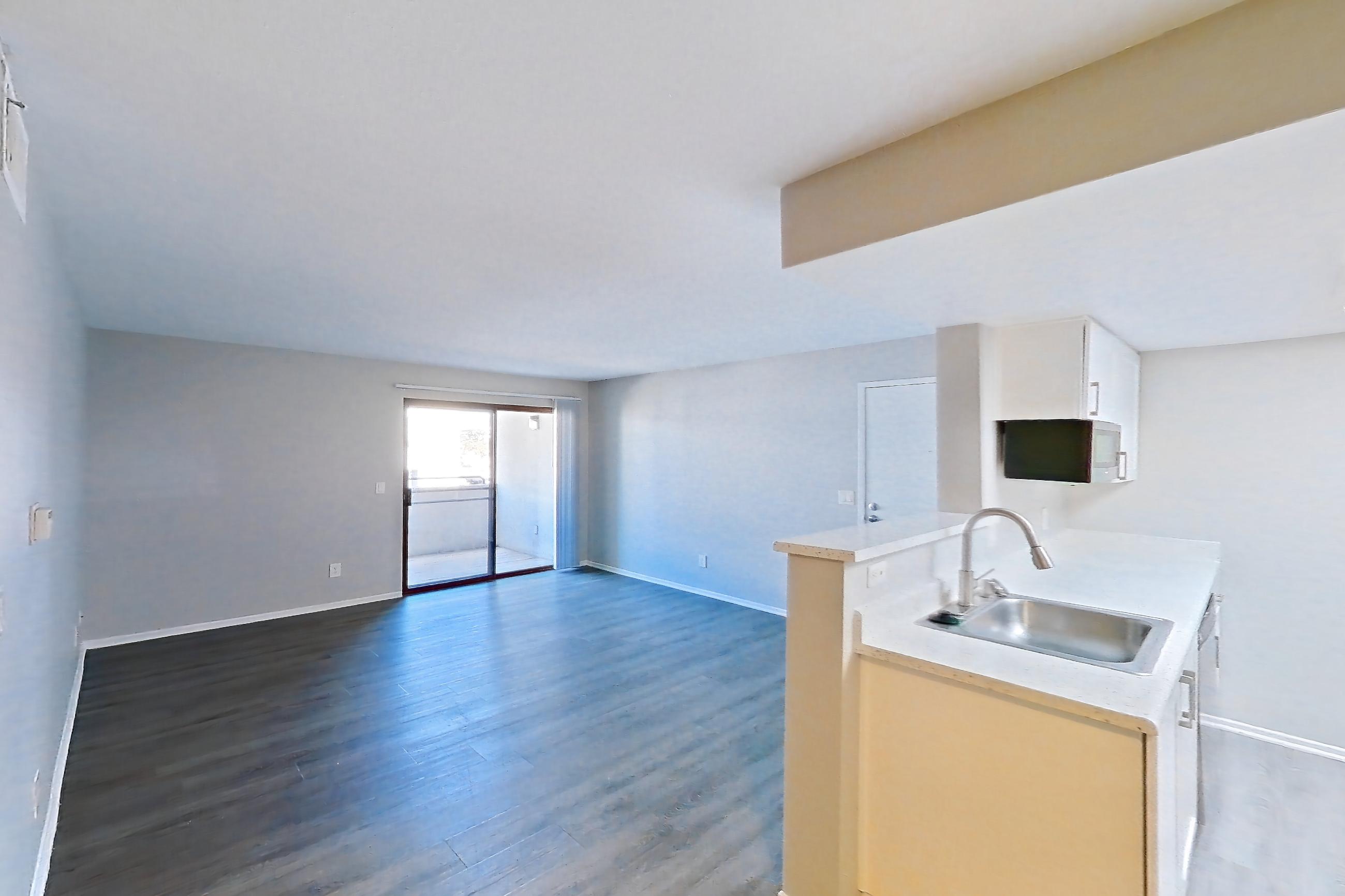 Dining room with dark wood-finish flooring, electric range, light countertops, light stone countertops, light wood-finish flooring, oven/range, refrigerator, and stainless steel appliances, Apartment 11 at Avana Rancho Cucamonga