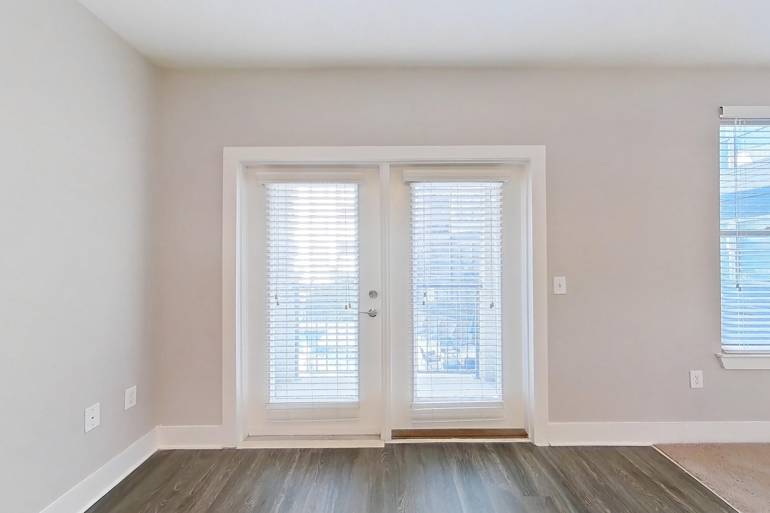 Living room with dark wood-finish flooring, Apartment 1278 at Cortland at the Hill