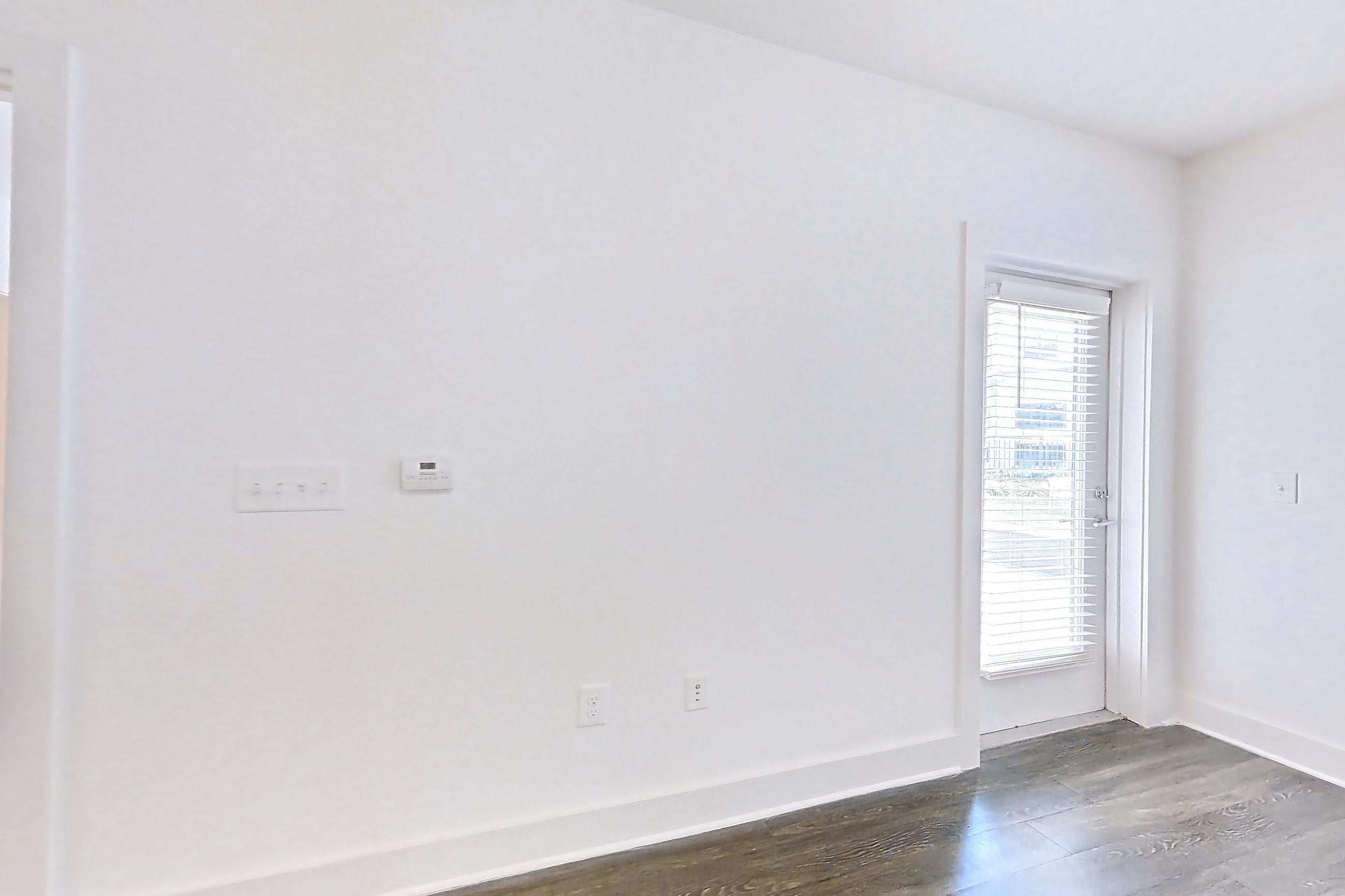 Living room with electric range, oven/range, and stainless steel appliances, Apartment 242 at Cortland at the Battery