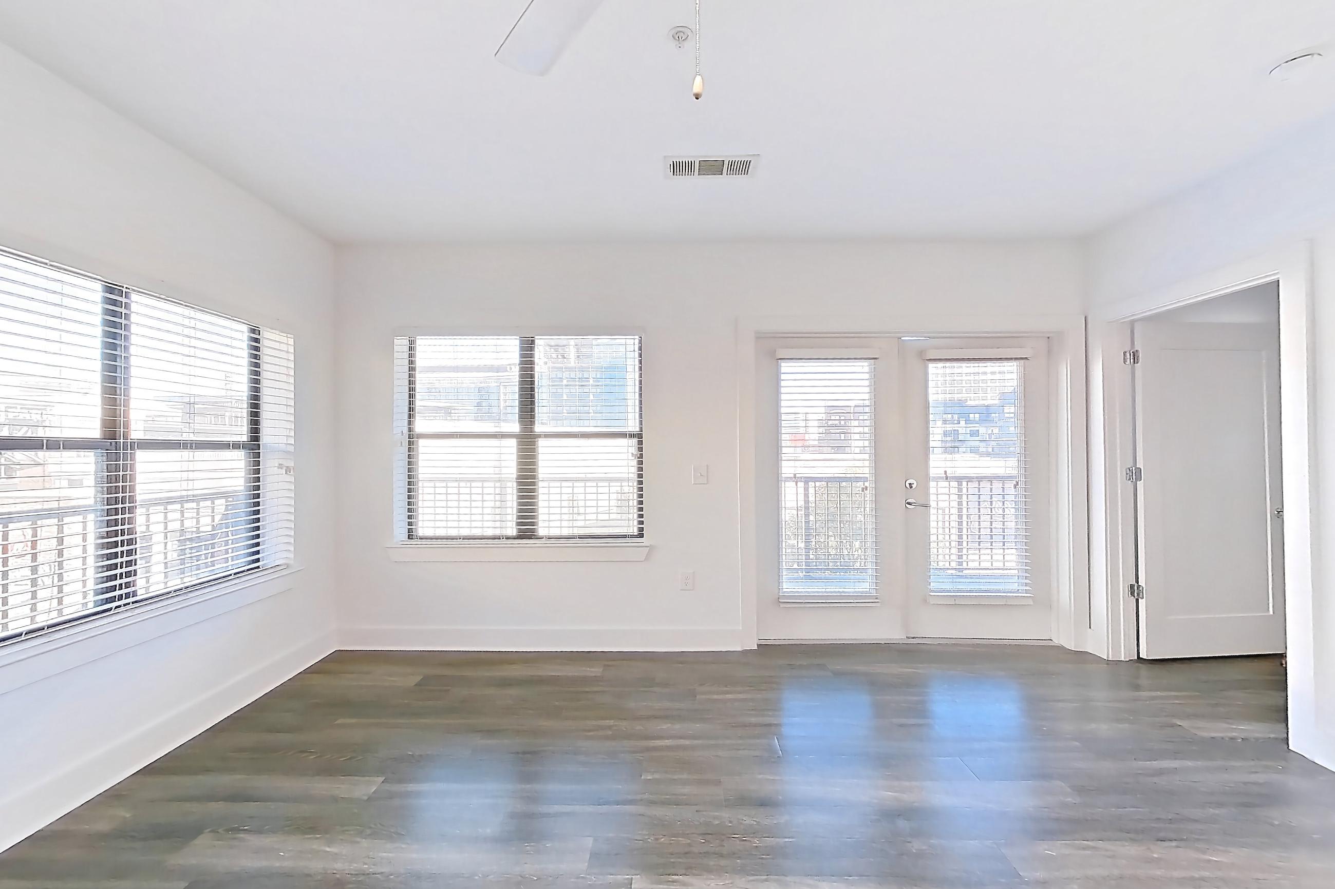 Living room with dark wood-finish flooring, Apartment 432 at Cortland at the Battery