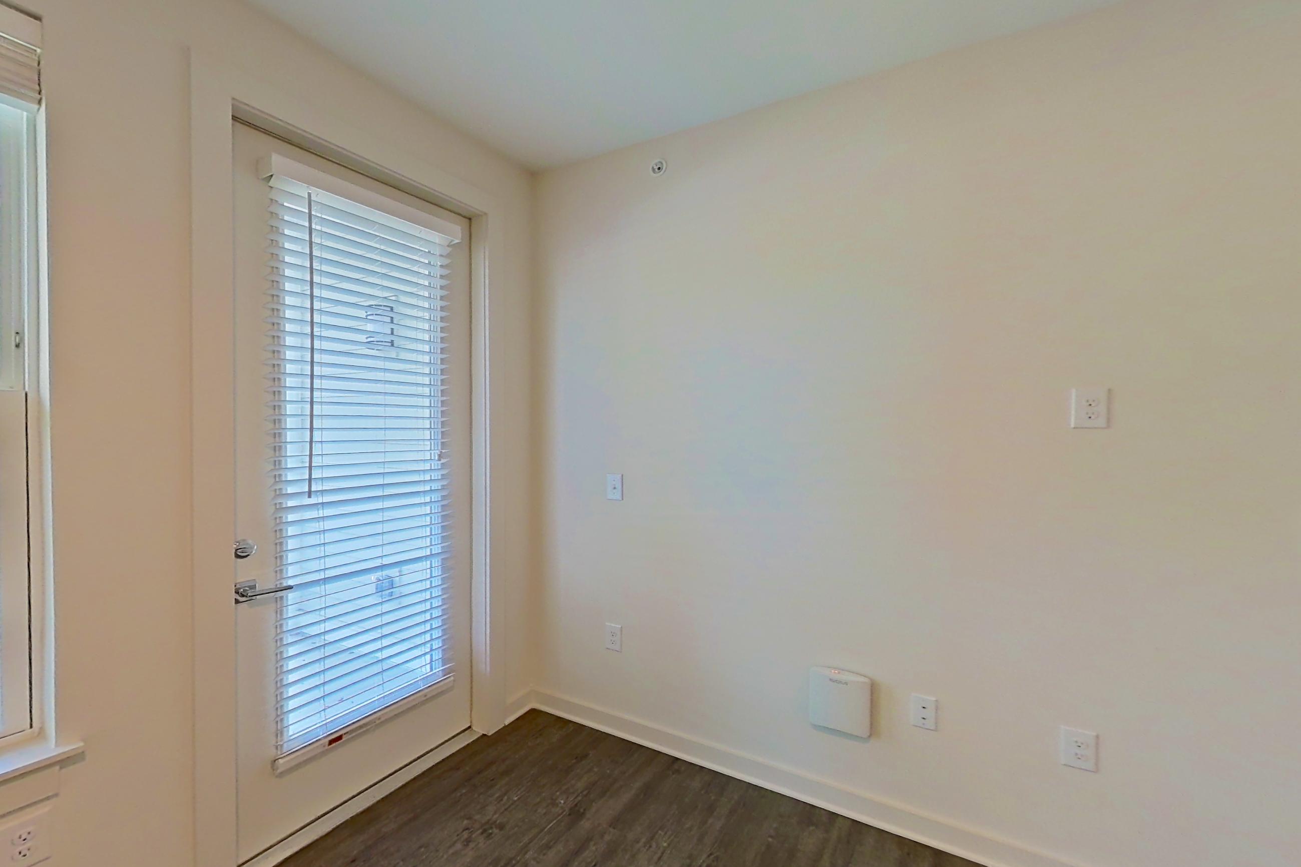 Living room with dark wood-finish flooring, Apartment 2-110 at Cortland Wren Northlake
