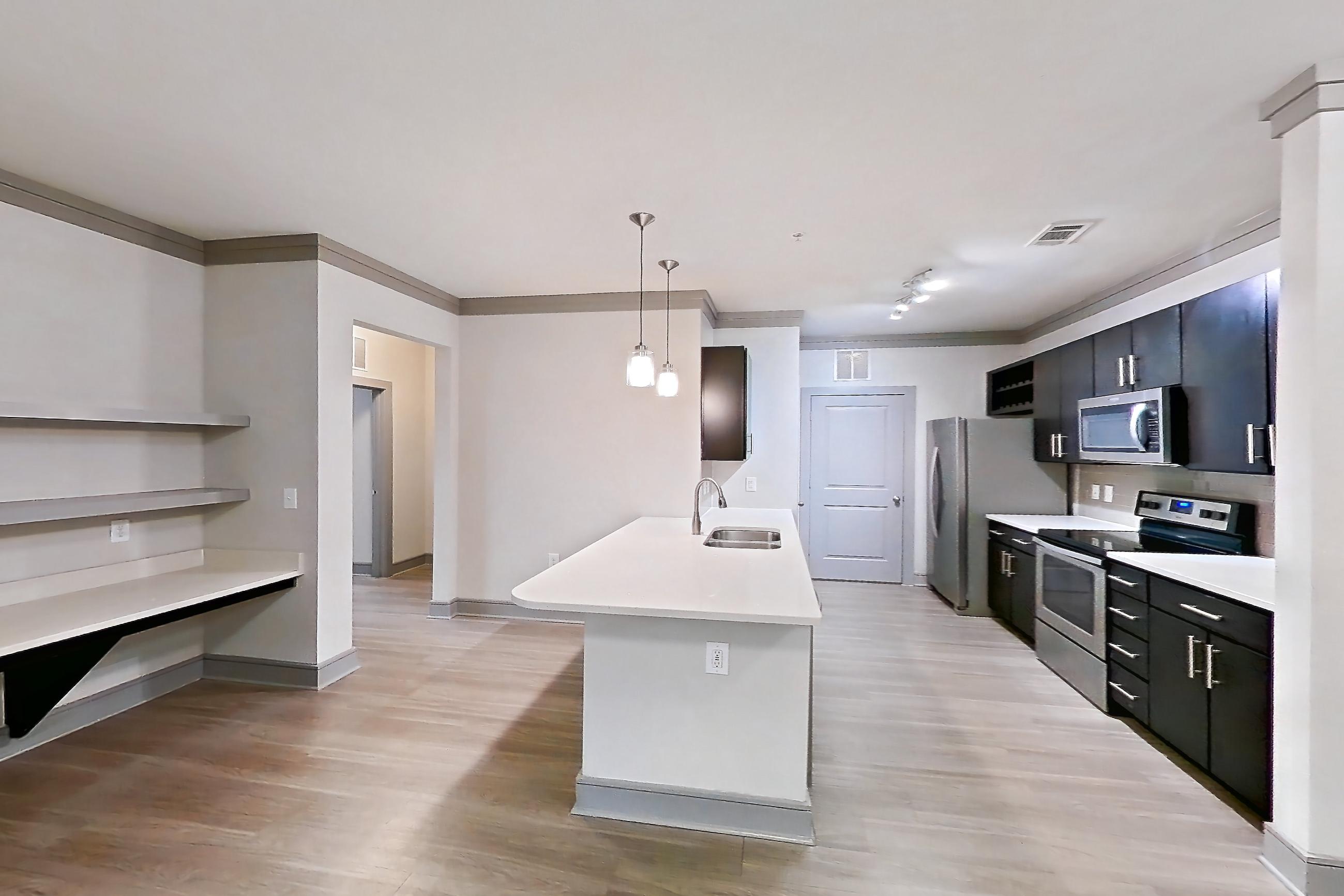 Dining room with electric range, light stone countertops, light wood-finish flooring, microwave, oven/range, refrigerator, and stainless steel appliances, Apartment 12207 at Cortland Phillips Creek Ranch