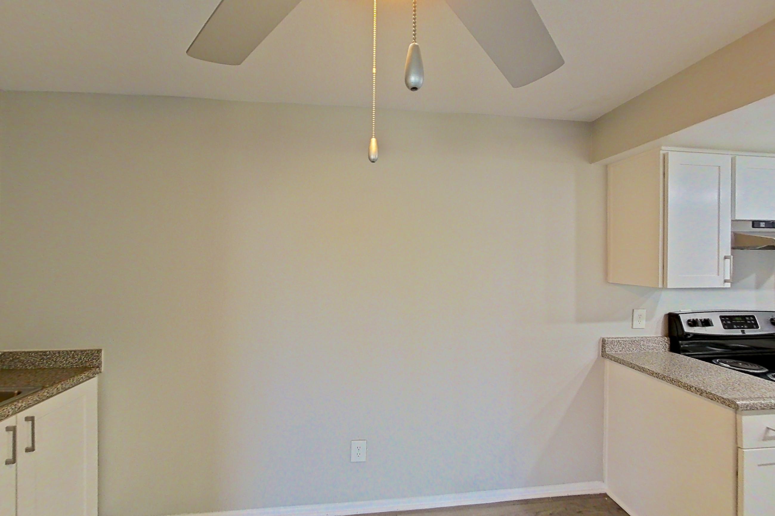 Dining area with electric range, light countertops, light wood-finish flooring, oven/range, refrigerator, stainless steel appliances, and white appliances, Apartment 12 at Avana Rancho Cucamonga