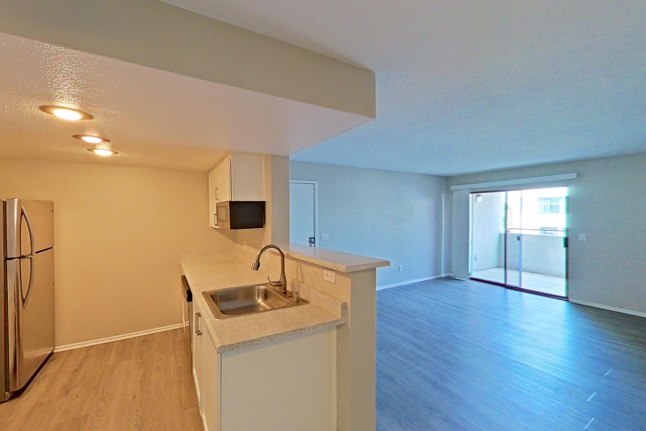 Dining area with dark wood-finish flooring and light countertops, Apartment 21 at Avana Rancho Cucamonga
