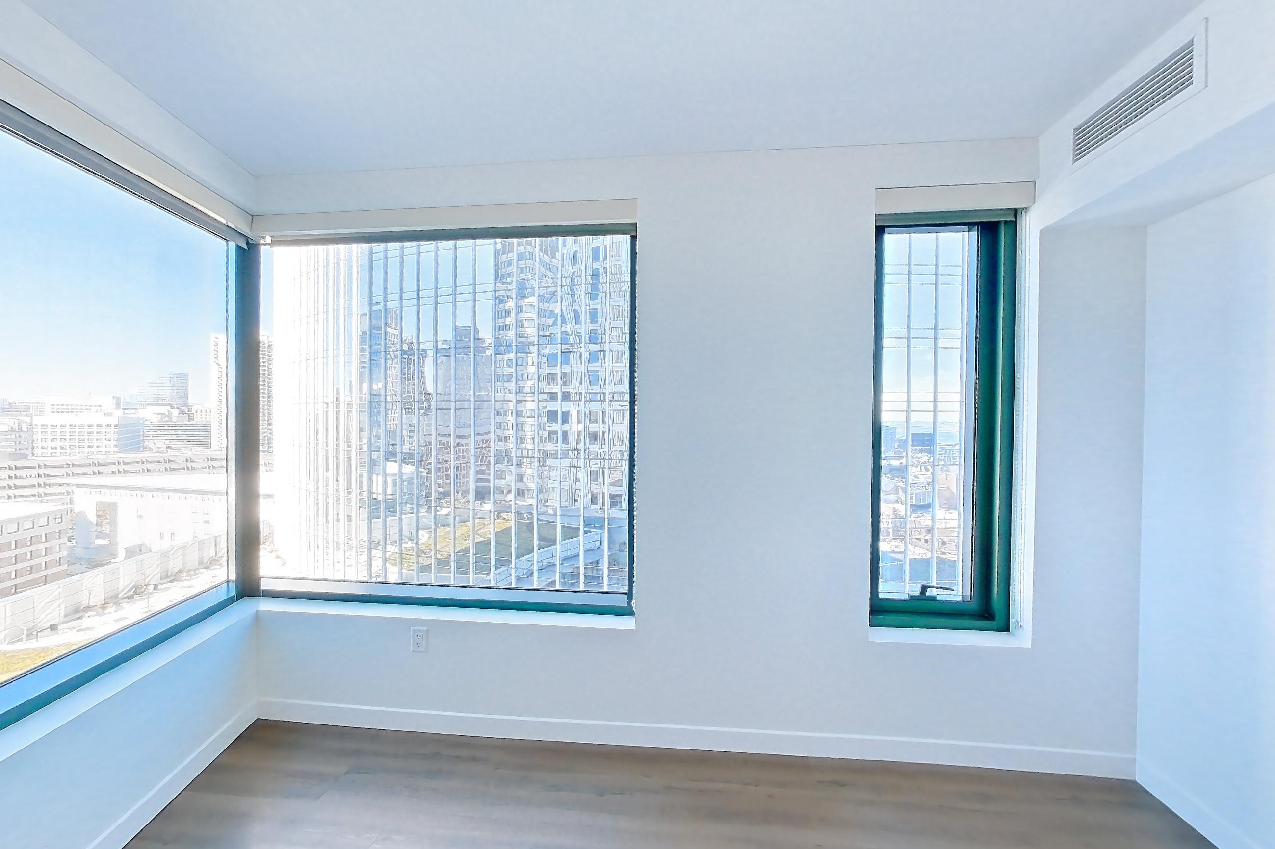 Living room with dark wood-finish flooring, Apartment 1501 at The Sudbury