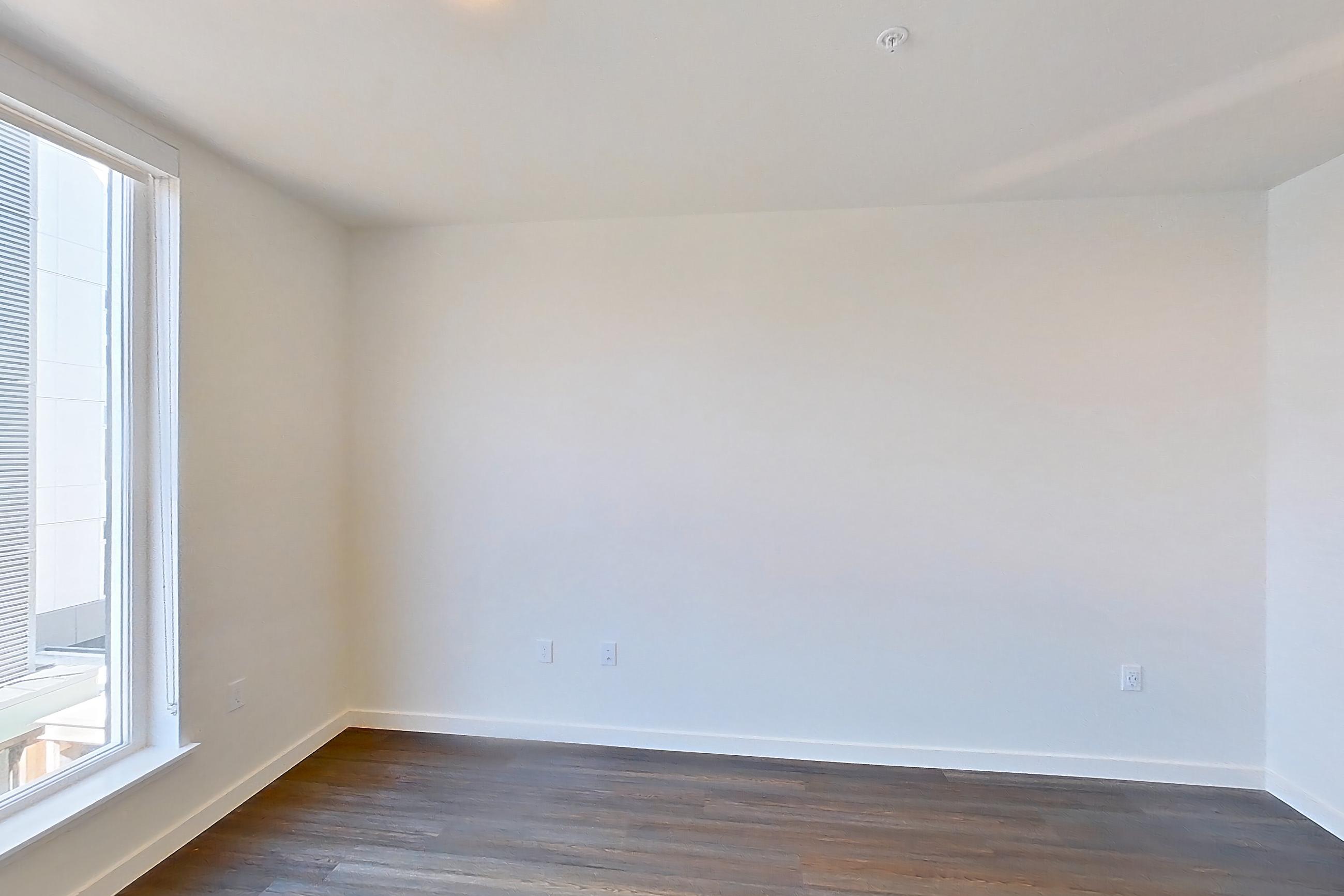 Living space with dark wood-finish flooring, Apartment 602 at Wayfarer