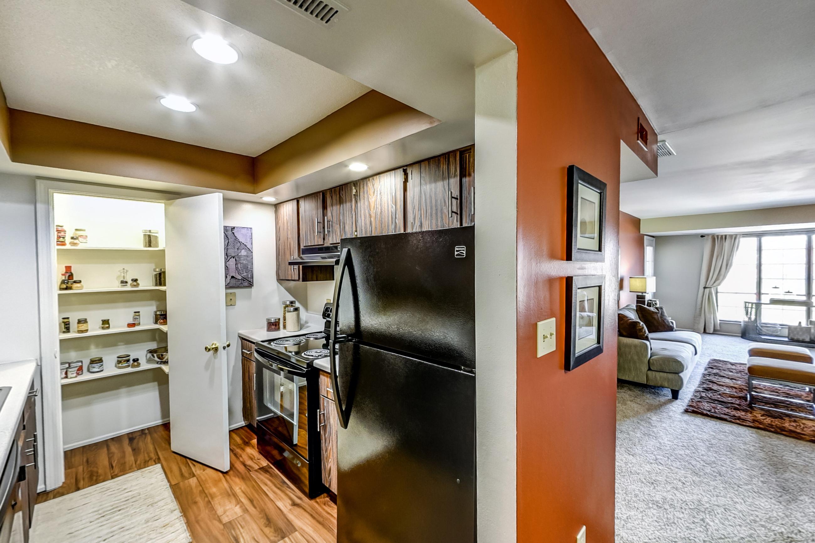 Dining room with black appliances, electric range, light countertops, oven/range, and refrigerator, Apartment Model 4 at Canterbury Green