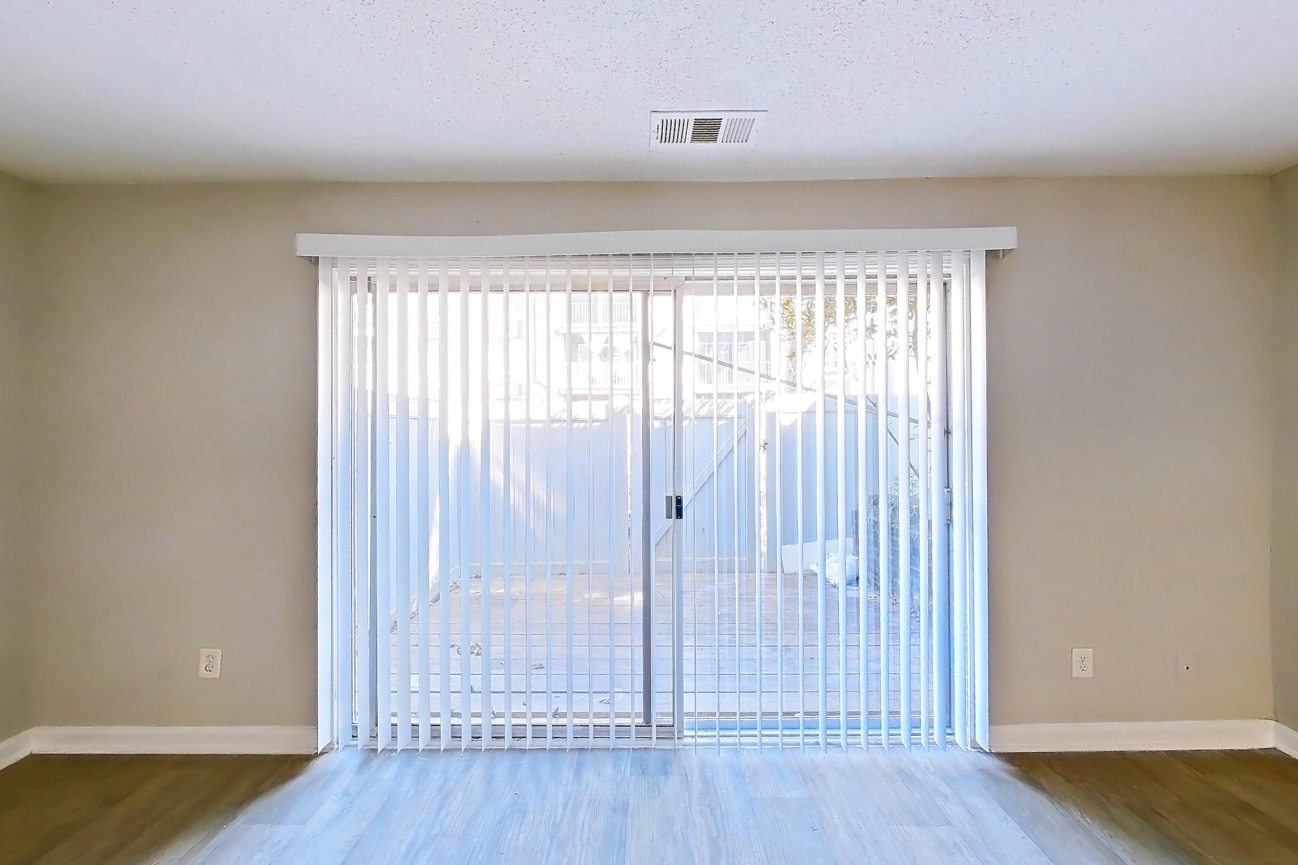 Living room with dark wood-finish flooring, Apartment H1456T at The Legacy at Druid Hills