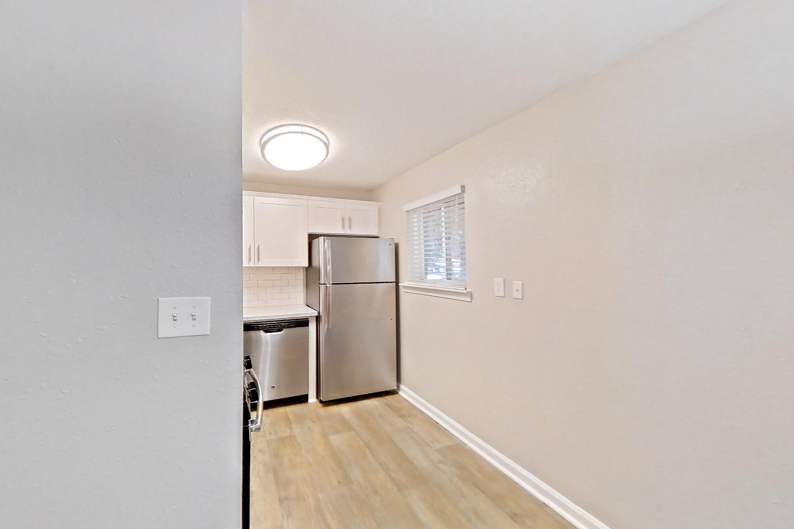 Dining room with light countertops and light wood-finish flooring, Apartment L1486C at The Legacy at Druid Hills