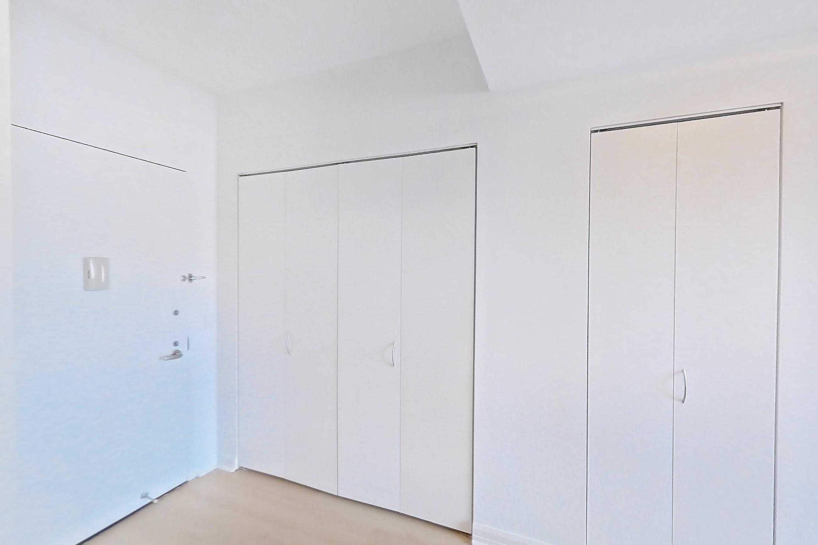 Kitchen with dishwasher, gas range, light countertops, light stone countertops, light tile flooring, light wood-finish flooring, microwave, oven/range, refrigerator, and stainless steel appliances, Apartment 1223 at The Octagon
