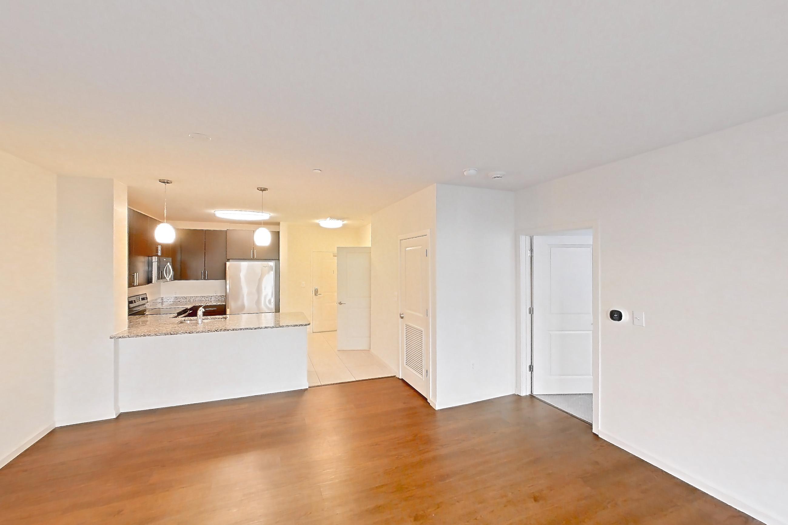 Living space with oven/range and stainless steel appliances, Apartment PE1-137 at Portside at East Pier