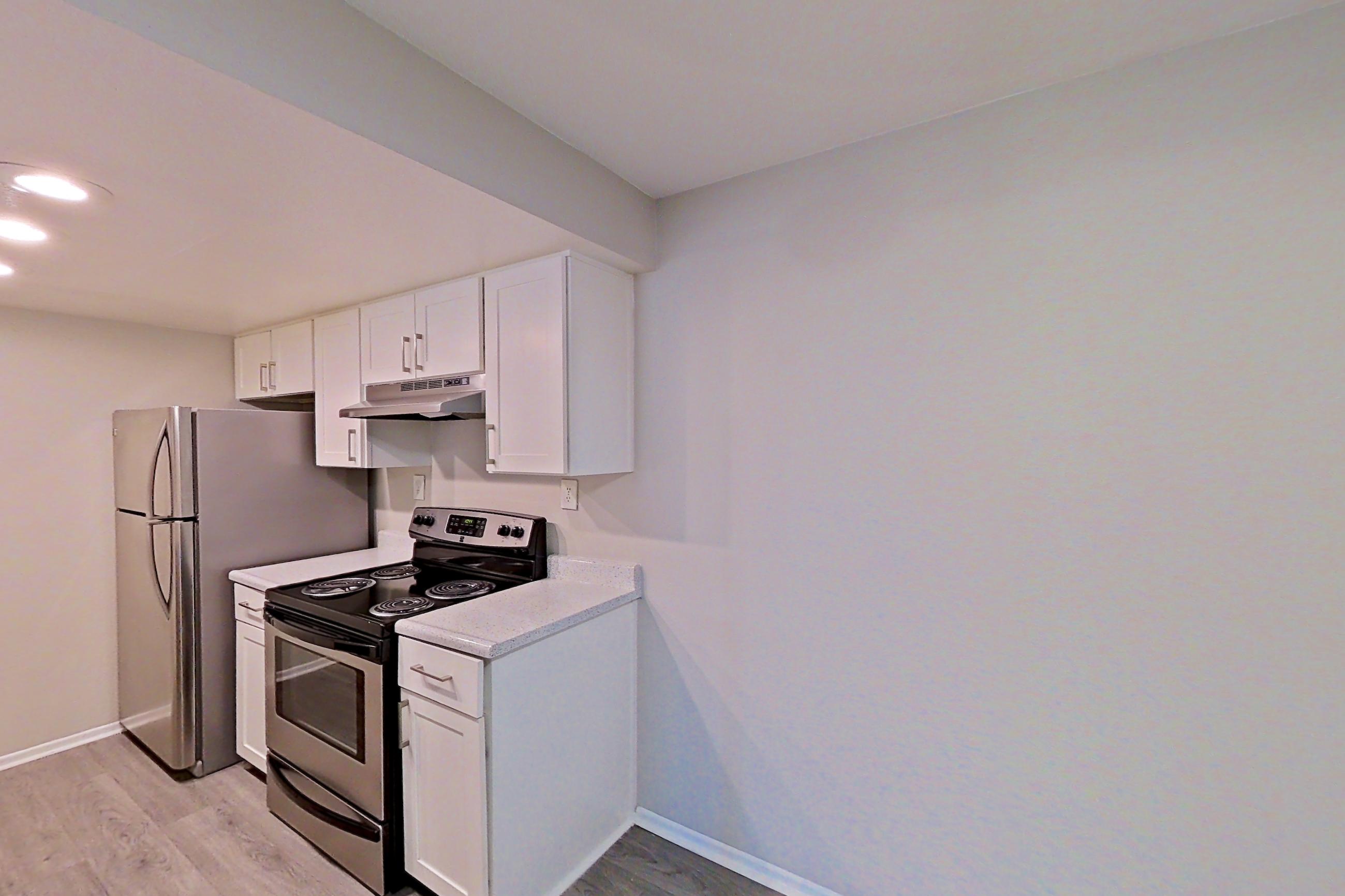 Dining area with gas range and light countertops, Apartment 18 at Avana Rancho Cucamonga