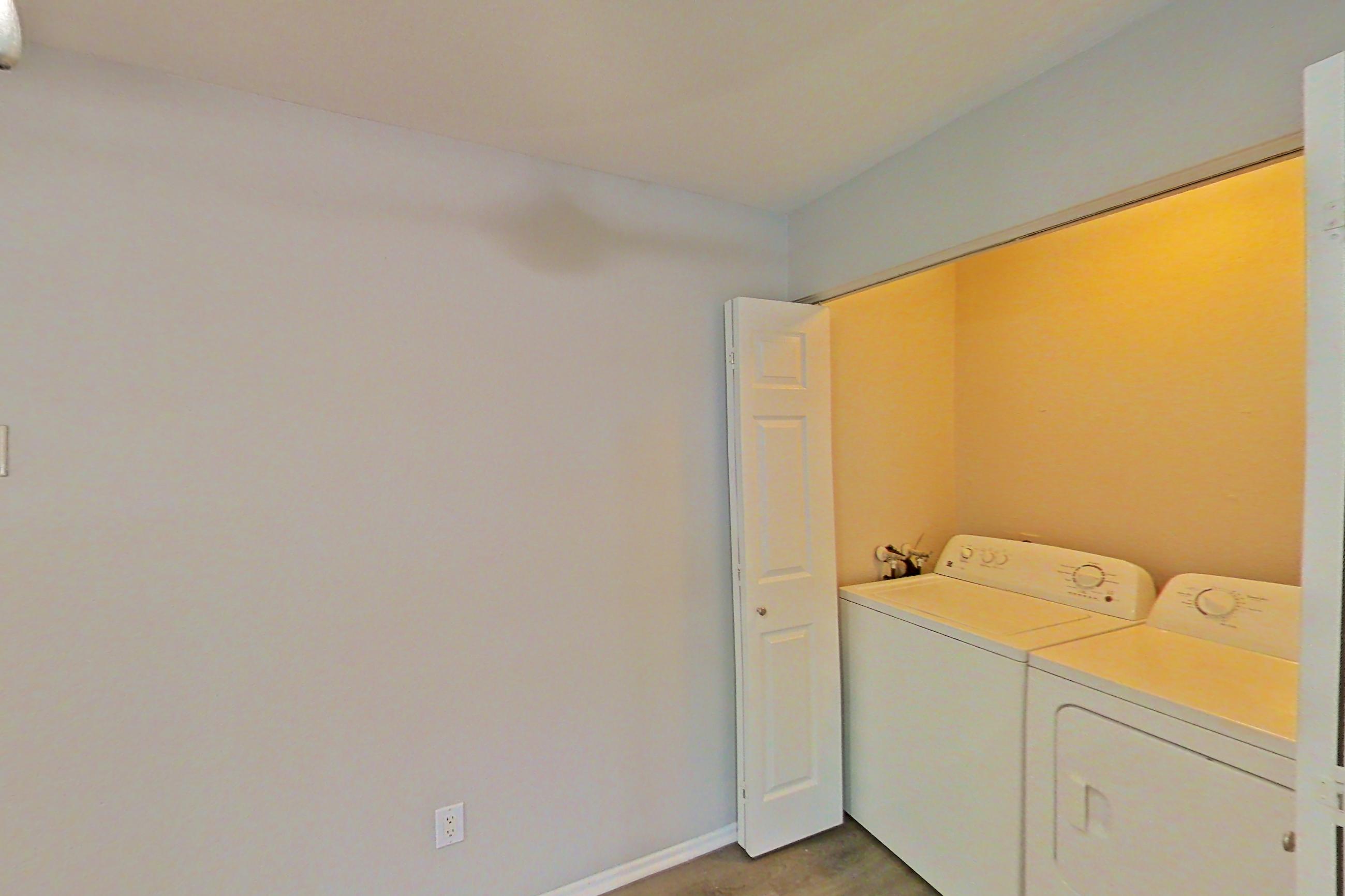 Dining area with in-unit laundry and light countertops, Apartment 02 at Avana Rancho Cucamonga