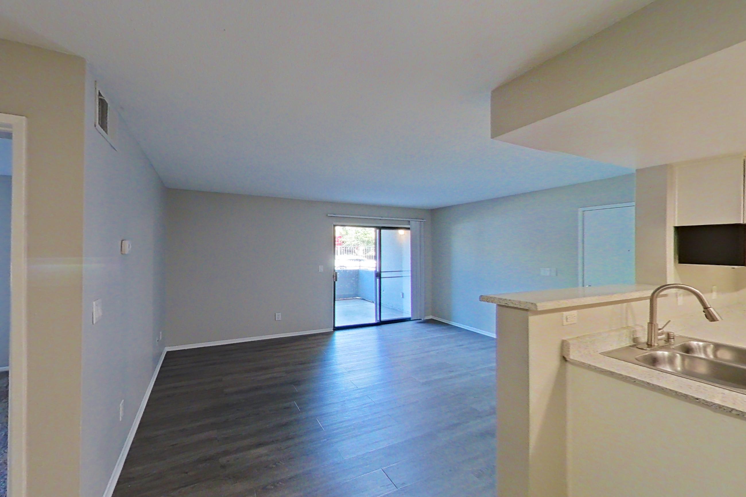 Dining area with in-unit laundry and light countertops, Apartment 02 at Avana Rancho Cucamonga