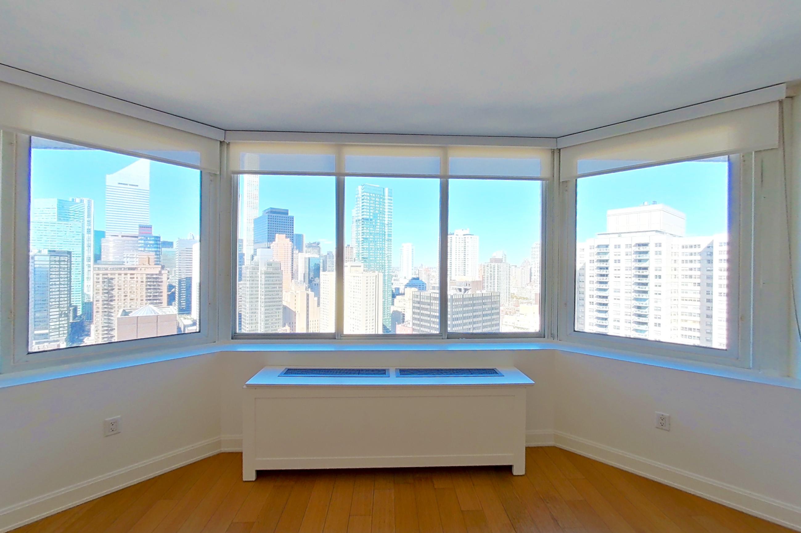 Living room with city view, light wood-finish flooring, skyline view, and wood-finish flooring, Apartment 3805 at Oriana
