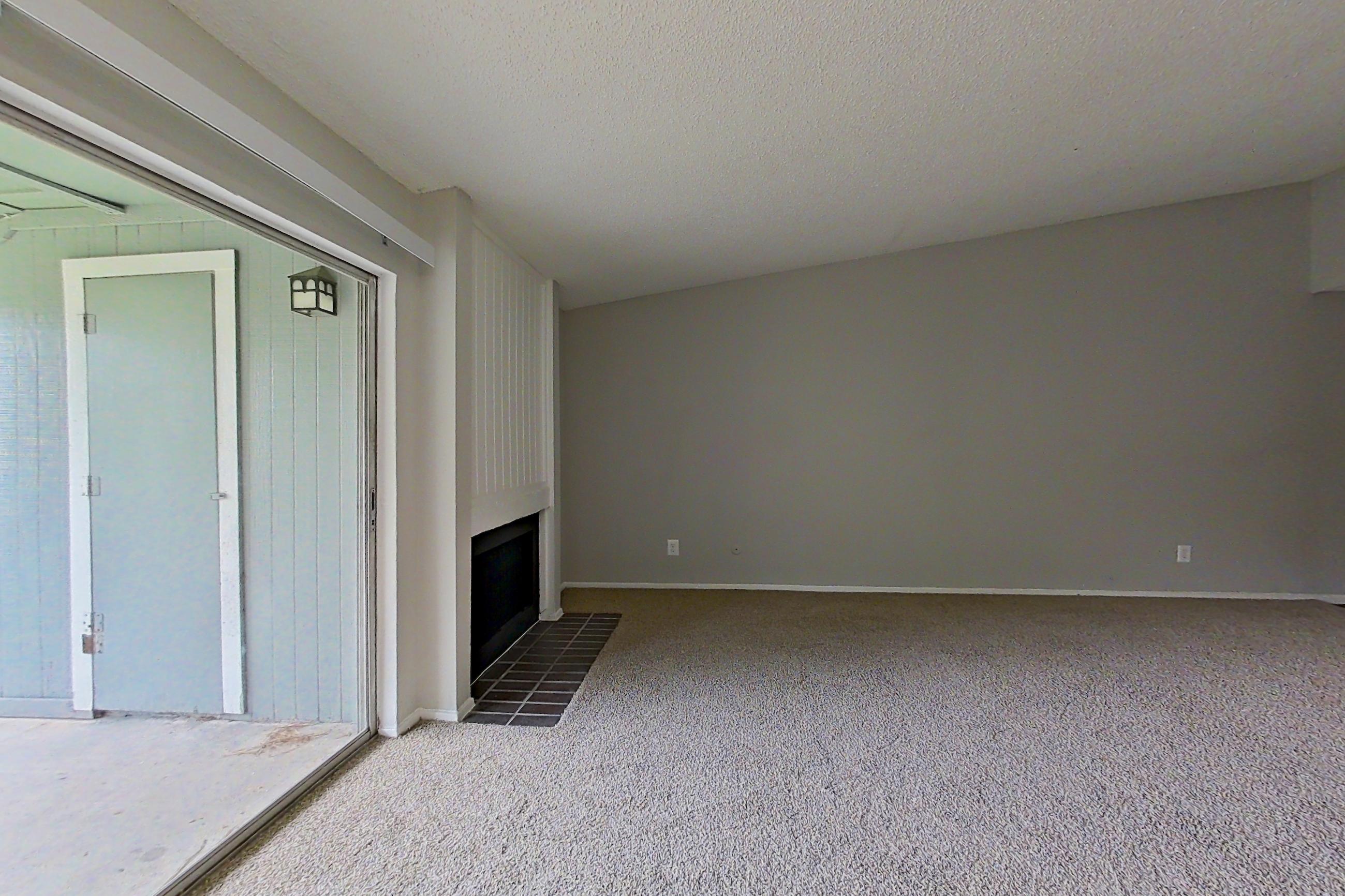 Living space with electric range, fireplace, oven/range, stainless steel appliances, and tile fireplace, Apartment 211 at The Cove Apartments