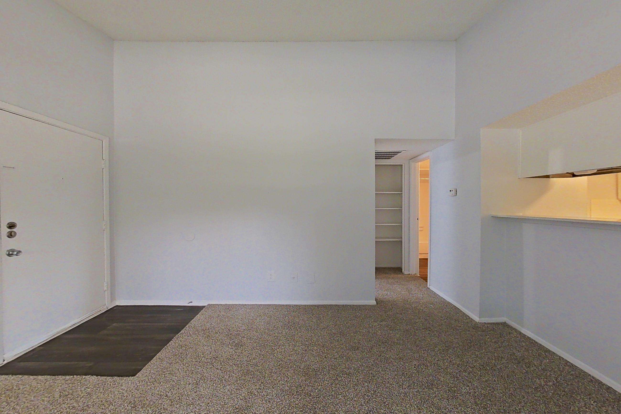 Living room with dark carpet, Apartment 1904 at The Cove Apartments