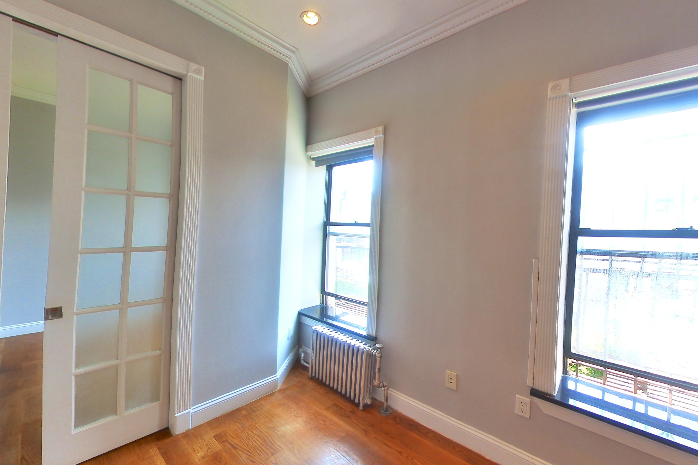 Living room with radiator heat, Apartment 6E at Centennial Properties