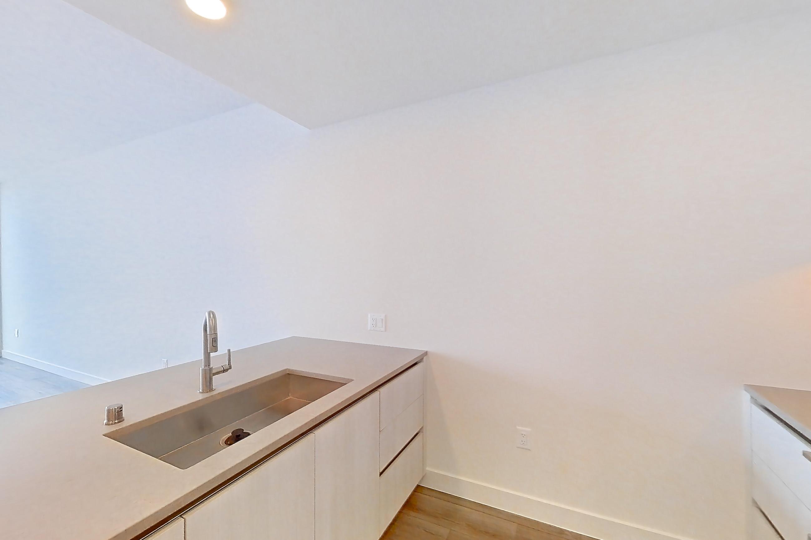 Kitchen with gas range, light countertops, light stone countertops, light wood-finish flooring, microwave, oven/range, and stainless steel appliances, Apartment 3213 at Alloy