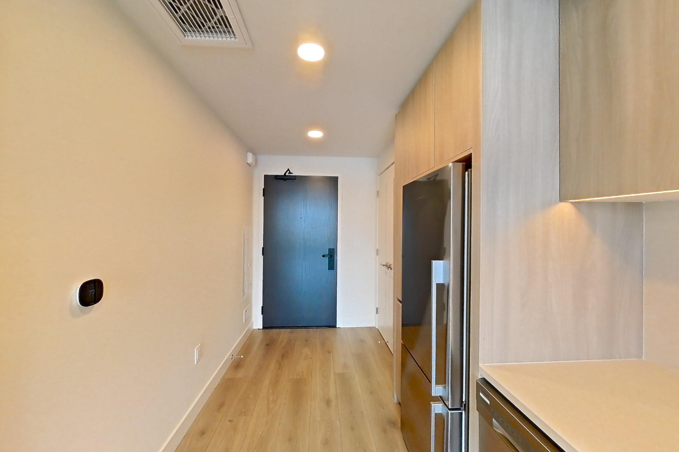 Kitchen with dishwasher, electric range, light stone countertops, light wood-finish flooring, oven/range, refrigerator, and stainless steel appliances, Apartment 1715 at Alloy