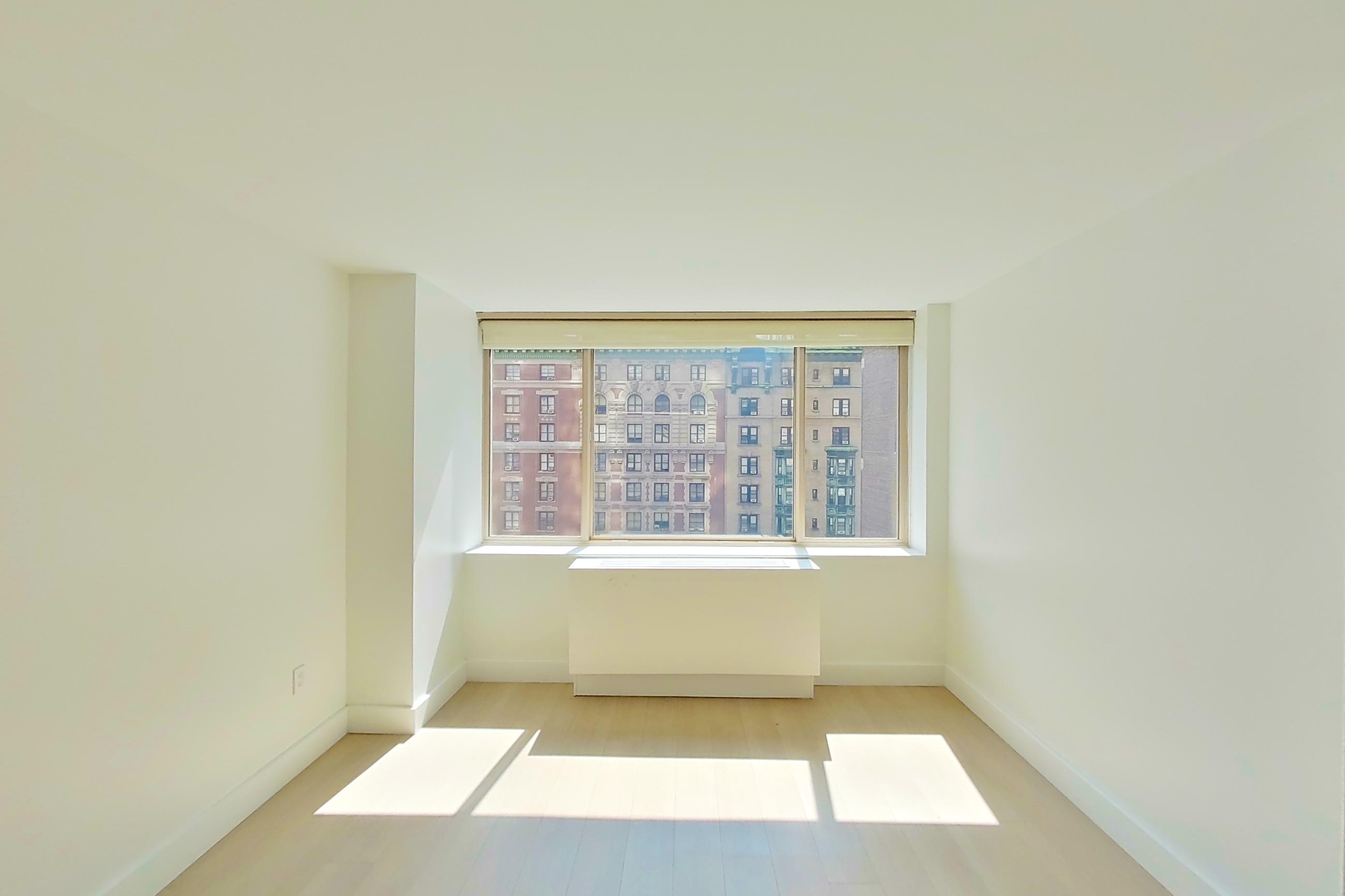 Living room with light wood-finish flooring, Apartment 12F at Anagram Nomad