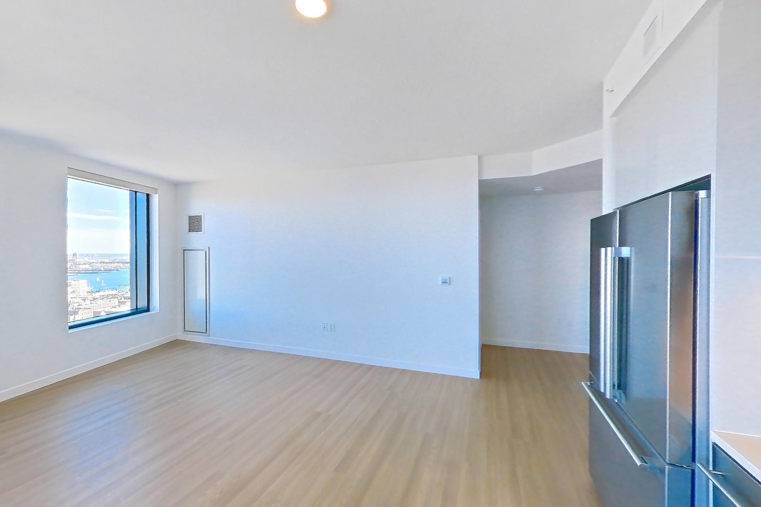 Kitchen with dishwasher, electric range, light countertops, light wood-finish flooring, microwave, oven/range, refrigerator, and stainless steel appliances, Apartment 2802 at The Sudbury