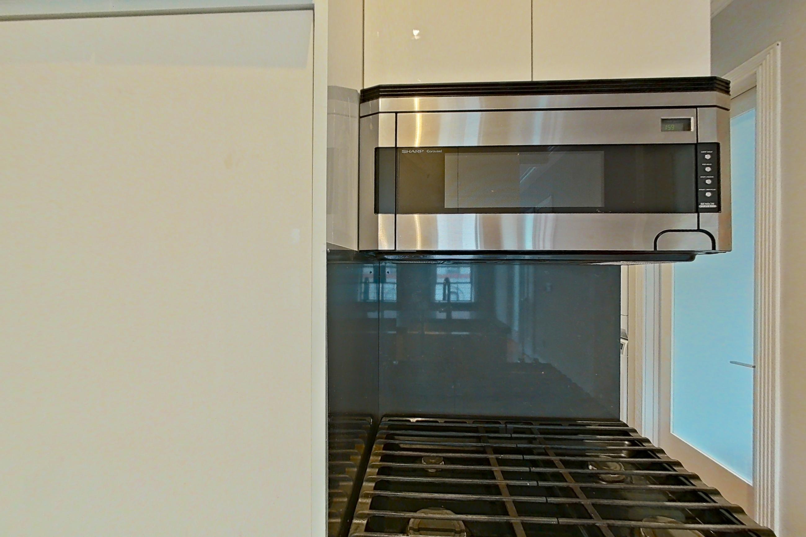 Kitchen with gas range, oven/range, radiator heat, and stainless steel appliances, Apartment 9 at Centennial Properties