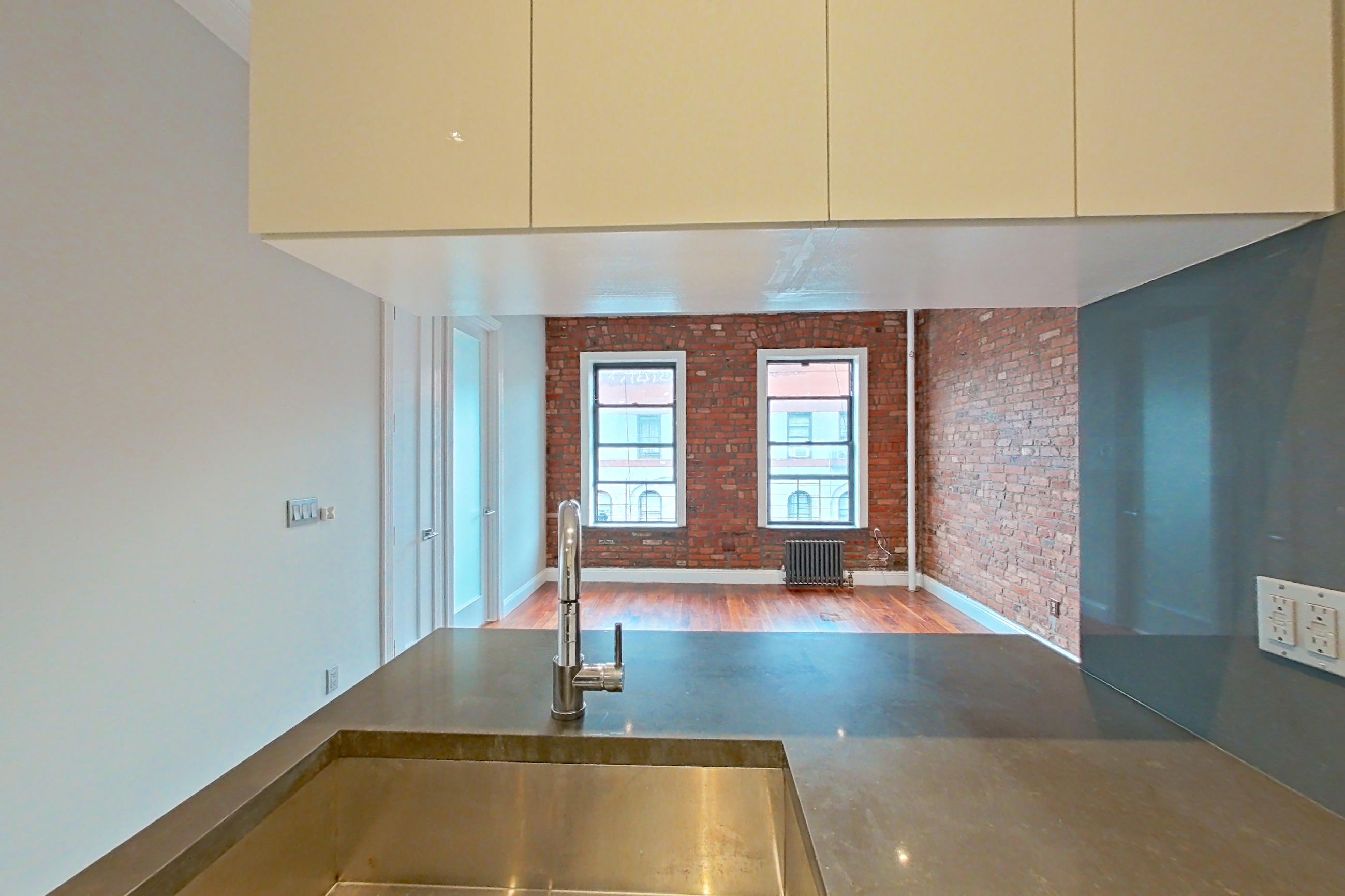 Kitchen with gas range, oven/range, radiator heat, and stainless steel appliances, Apartment 9 at Centennial Properties