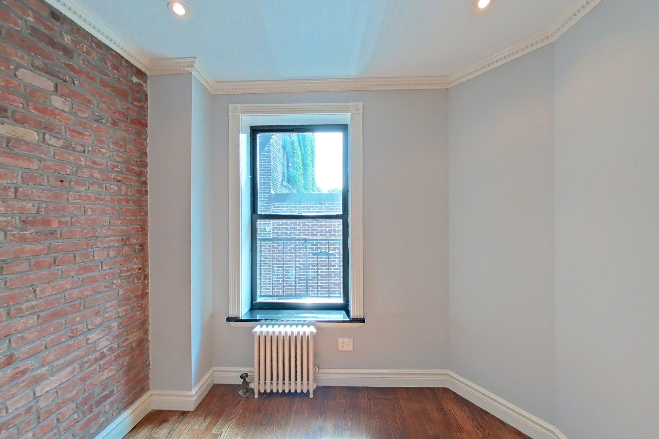 Living space with radiator heat, Apartment 29 at Centennial Properties
