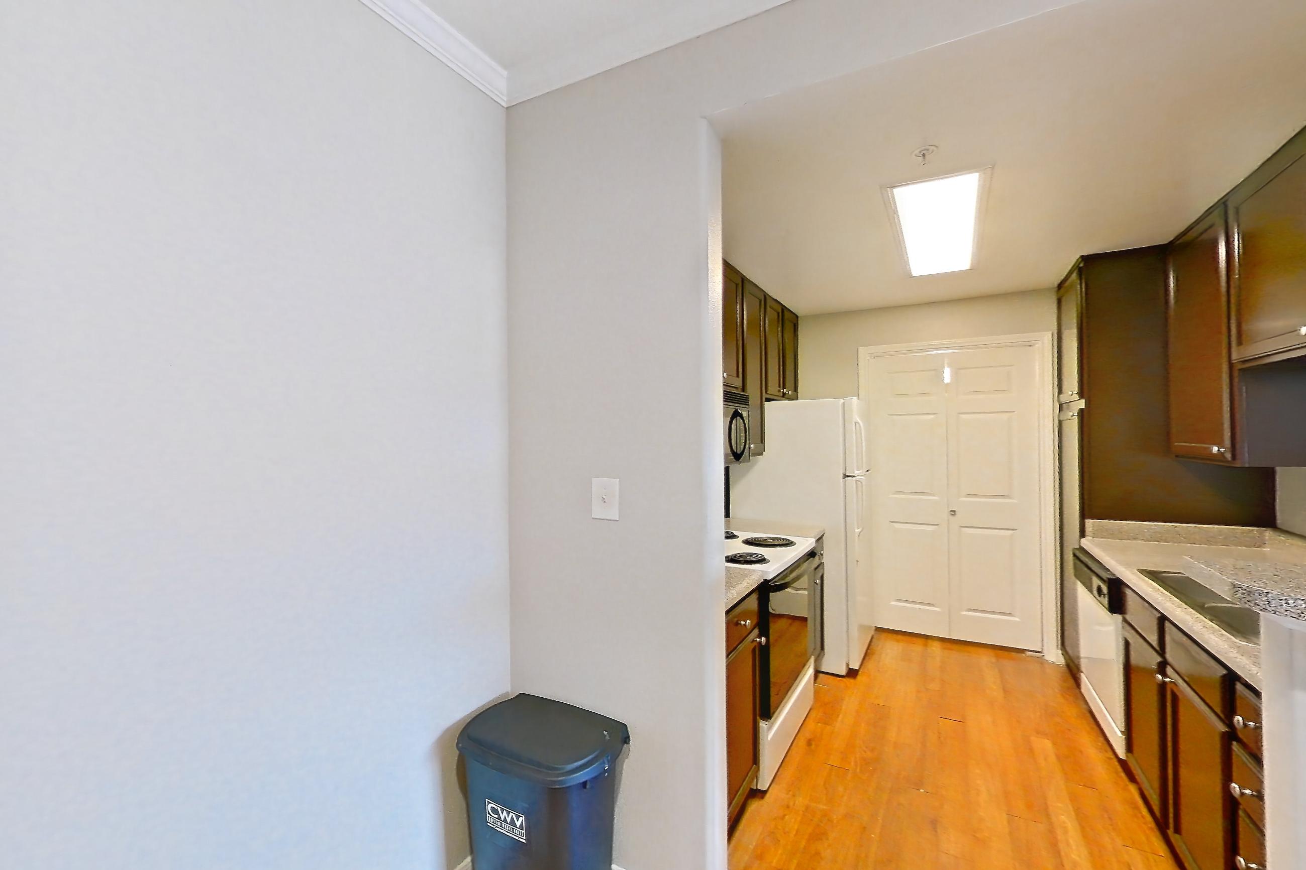 Dining room with dishwasher, electric range, light stone countertops, light wood-finish flooring, oven/range, refrigerator, white appliances, and wood-finish flooring, Apartment 0131 at Marquis on Westheimer