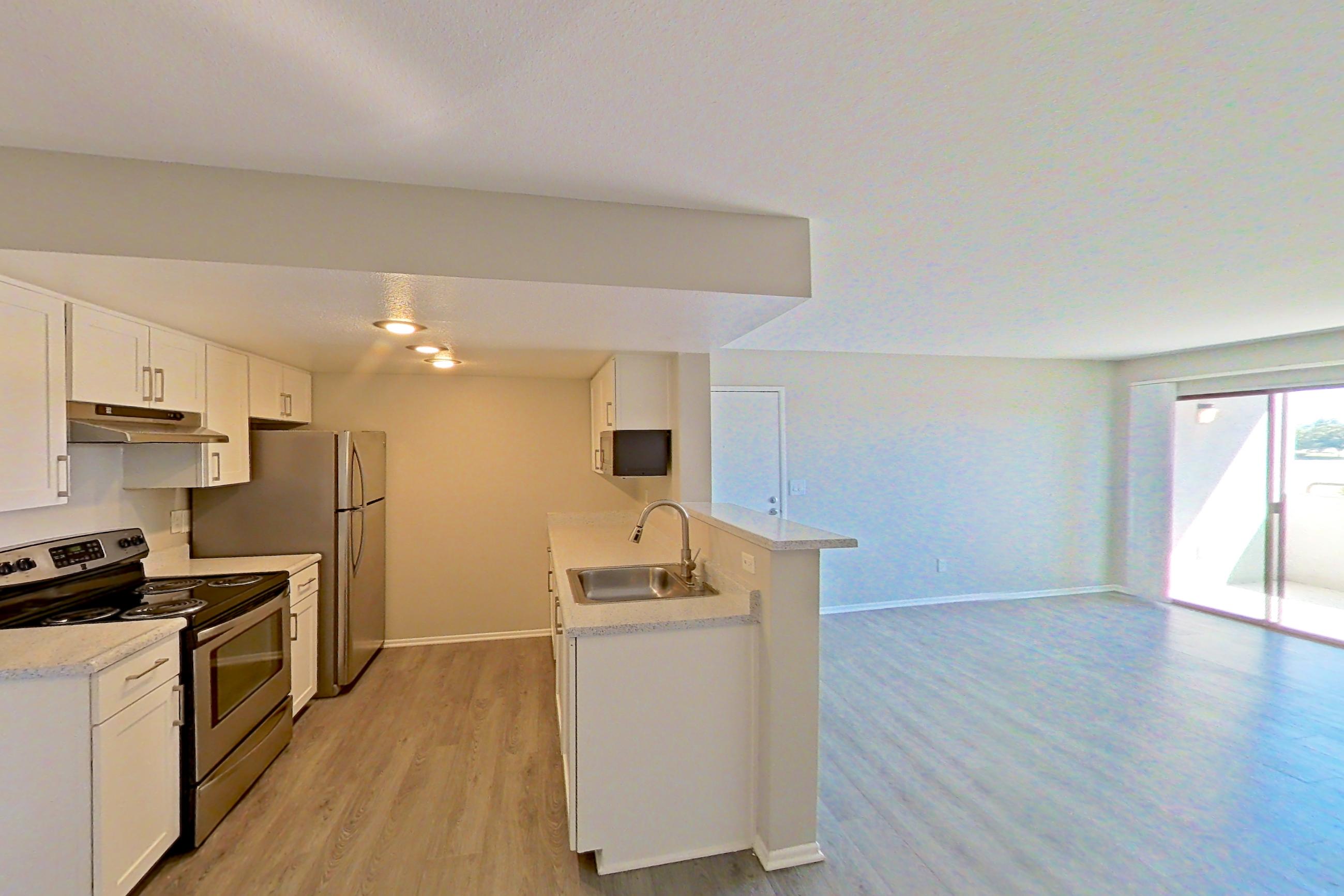 Dining area with light countertops and light wood-finish flooring, Apartment 24 at Avana Rancho Cucamonga
