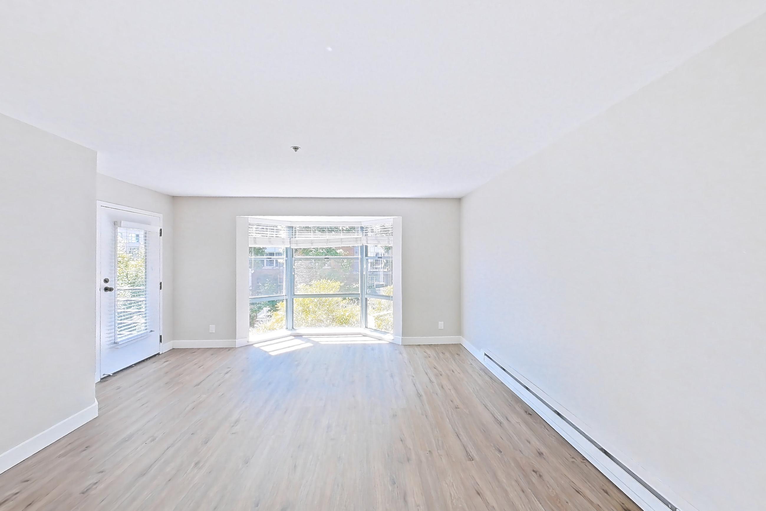 Dining room with baseboard heating, light wood-finish flooring, and wood-finish flooring, Apartment 1-319 at Bayside Village
