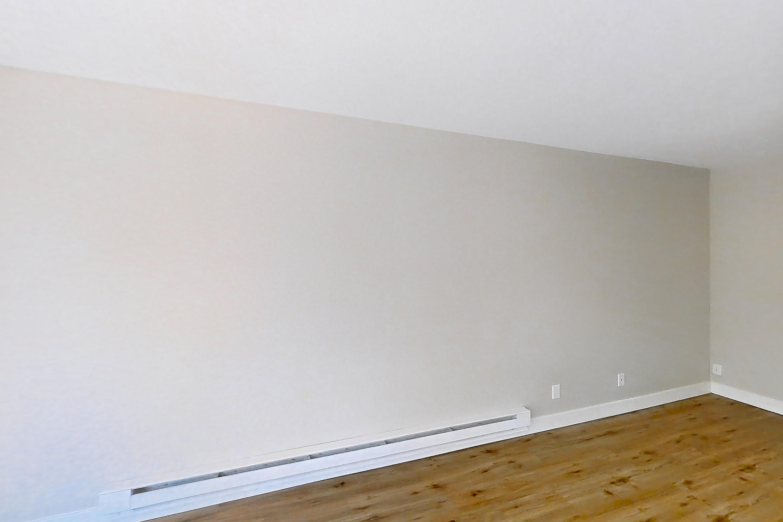 Living room with baseboard heating and light wood-finish flooring, Apartment 1-319 at Bayside Village