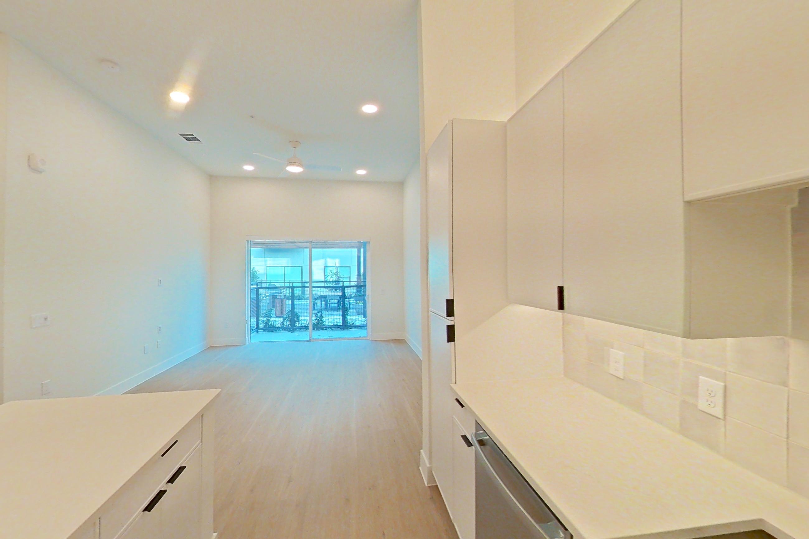 Kitchen with dishwasher, electric range, light countertops, light wood-finish flooring, oven/range, refrigerator, and stainless steel appliances, Apartment 160 at Lantower Midtown