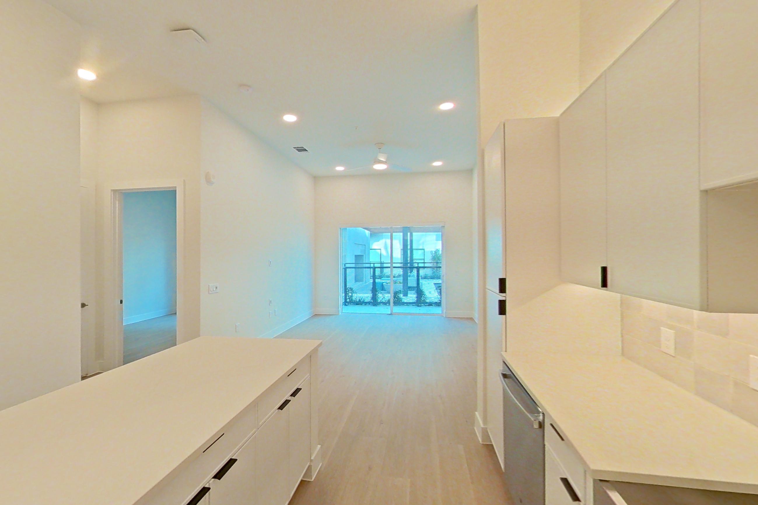 Kitchen with dishwasher, electric range, light countertops, light wood-finish flooring, microwave, oven/range, refrigerator, and stainless steel appliances, Apartment 162 at Lantower Midtown