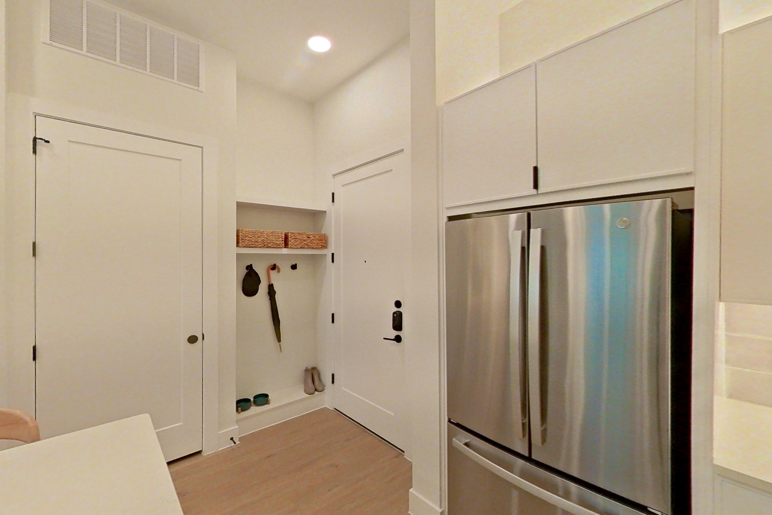 Kitchen with dishwasher, electric range, light countertops, light wood-finish flooring, microwave, refrigerator, and stainless steel appliances, Apartment 172 at Lantower Midtown