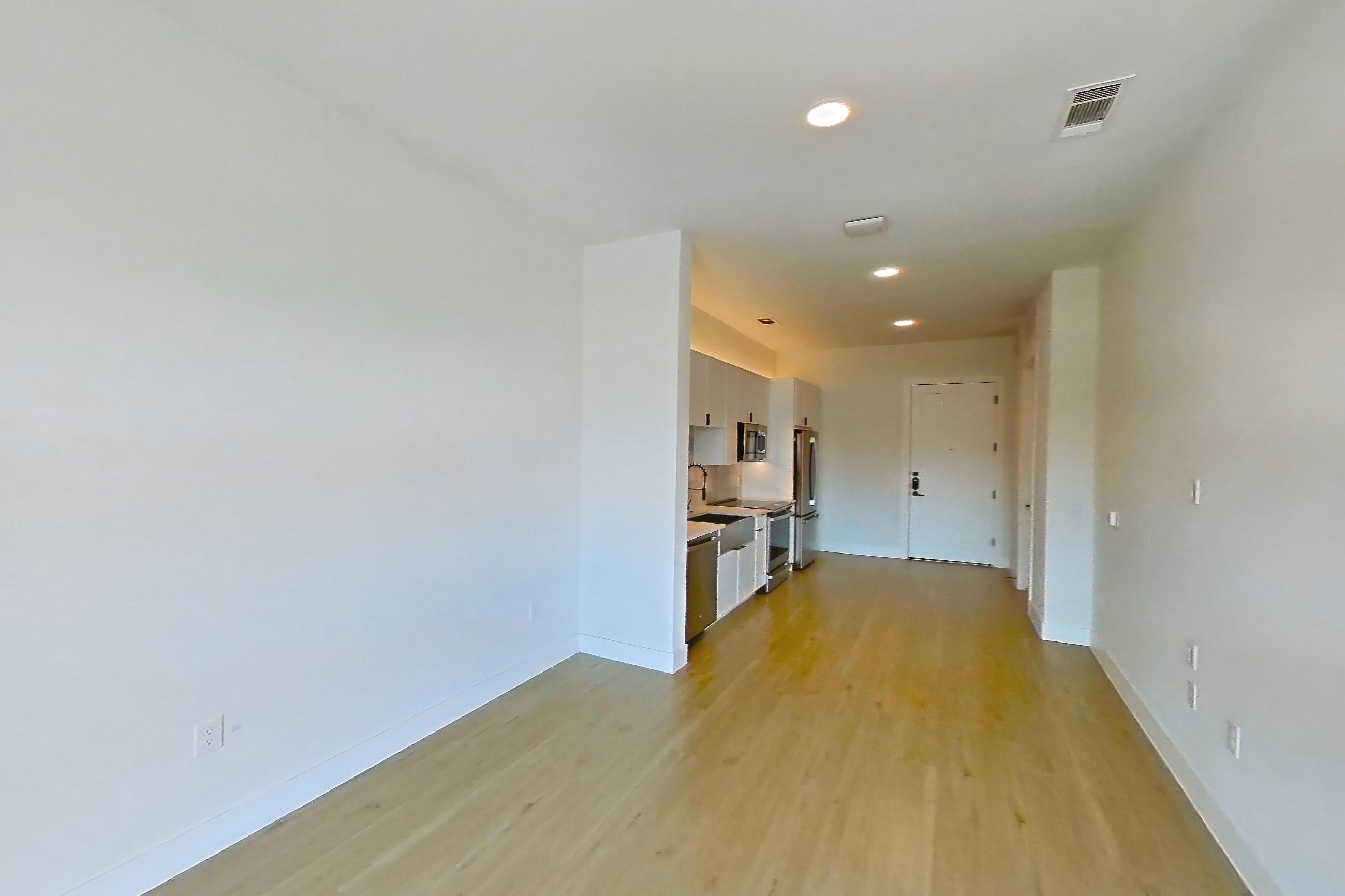 Living space with electric range, light wood-finish flooring, oven/range, refrigerator, stainless steel appliances, and wood-finish flooring, Apartment 314 at Lantower Midtown