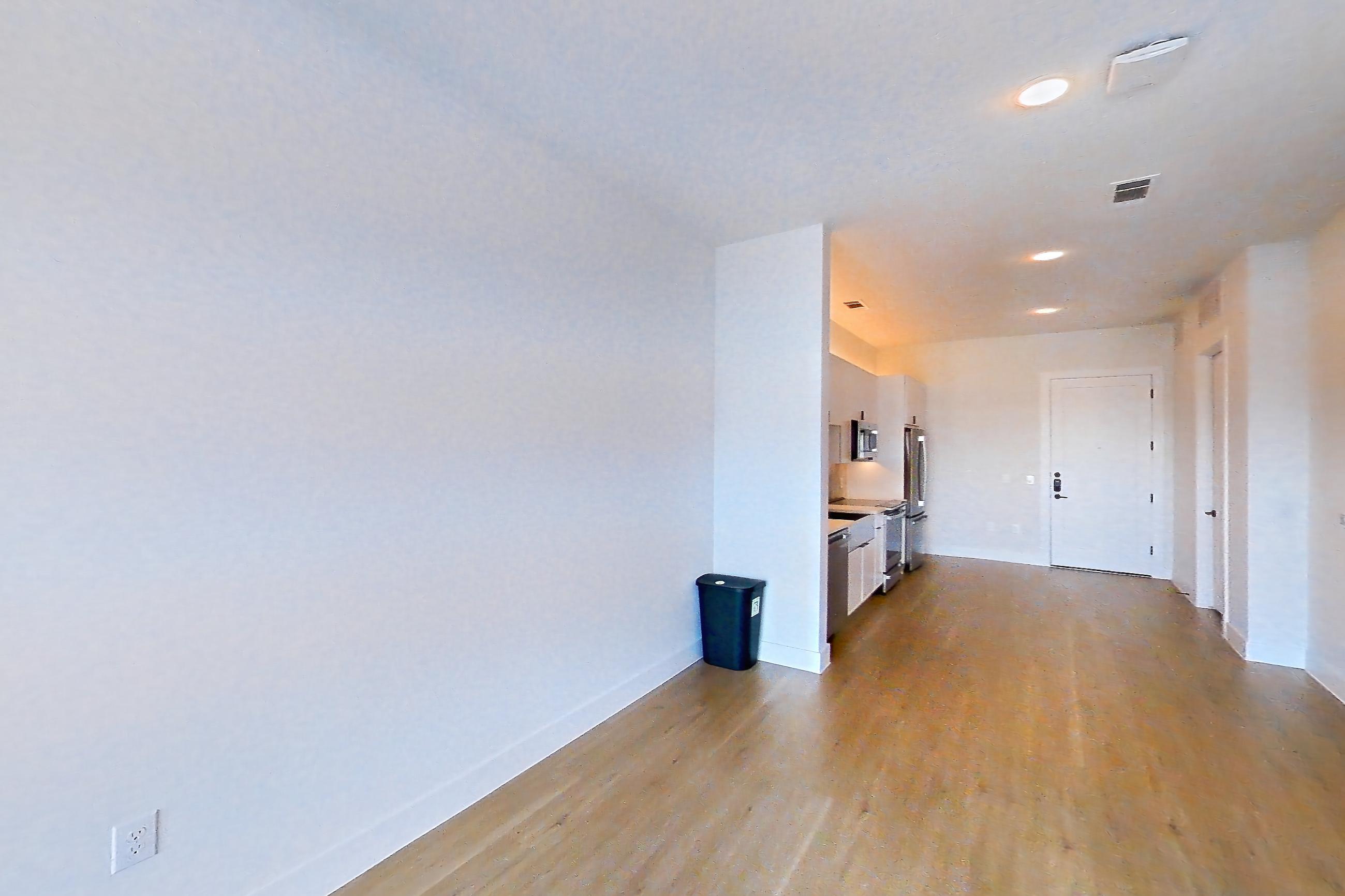 Living space with dishwasher, light wood-finish flooring, and stainless steel appliances, Apartment 505 at Lantower Midtown