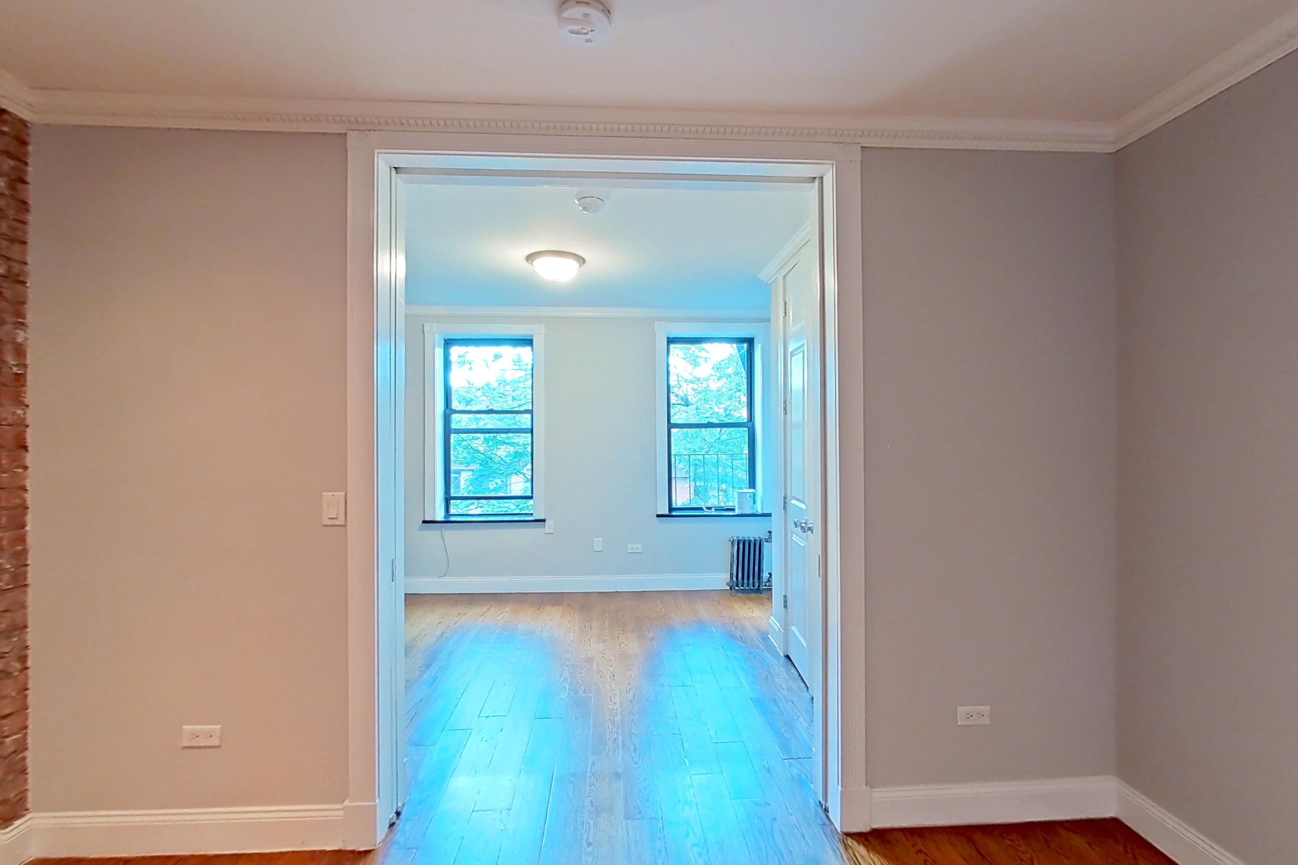 Living space with radiator heat, Apartment E2 at Centennial Properties