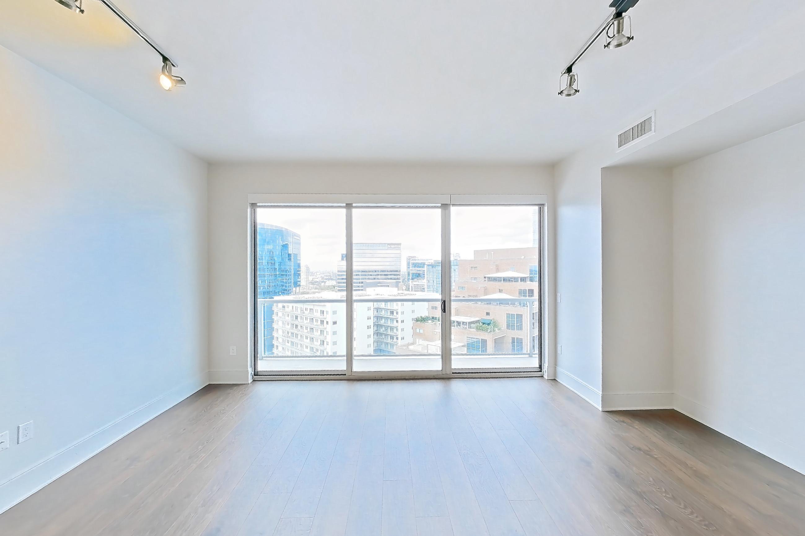 Living room with dark wood-finish flooring, Apartment 2109 at Cortland on McKinney